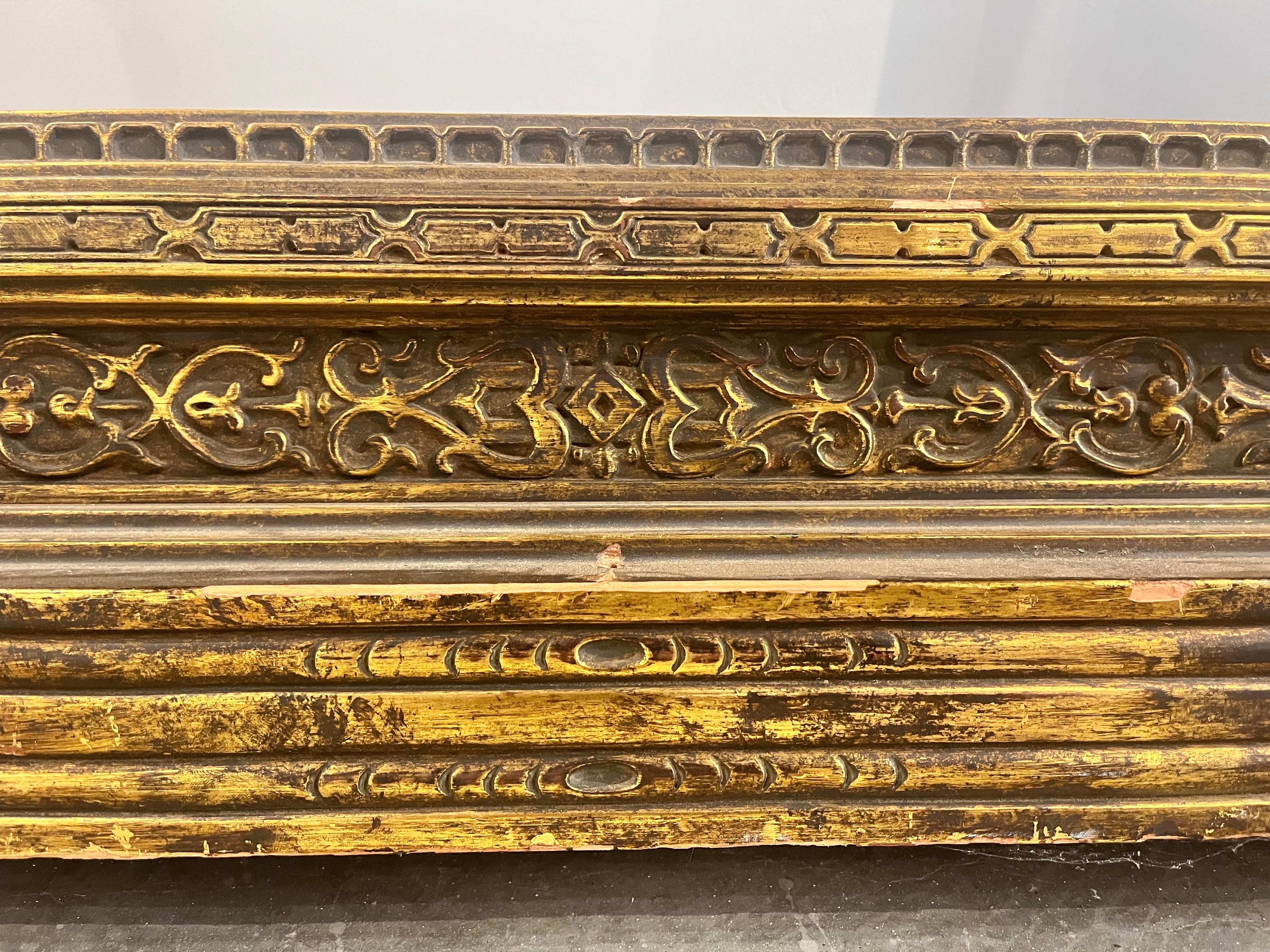 An antique circa early 1900's monumental American style hand carved and gilt frieze design painting or picture frame in the style of Carrig-Rohane. This style of frame is mostly associated with the works of the famous American artist and picture