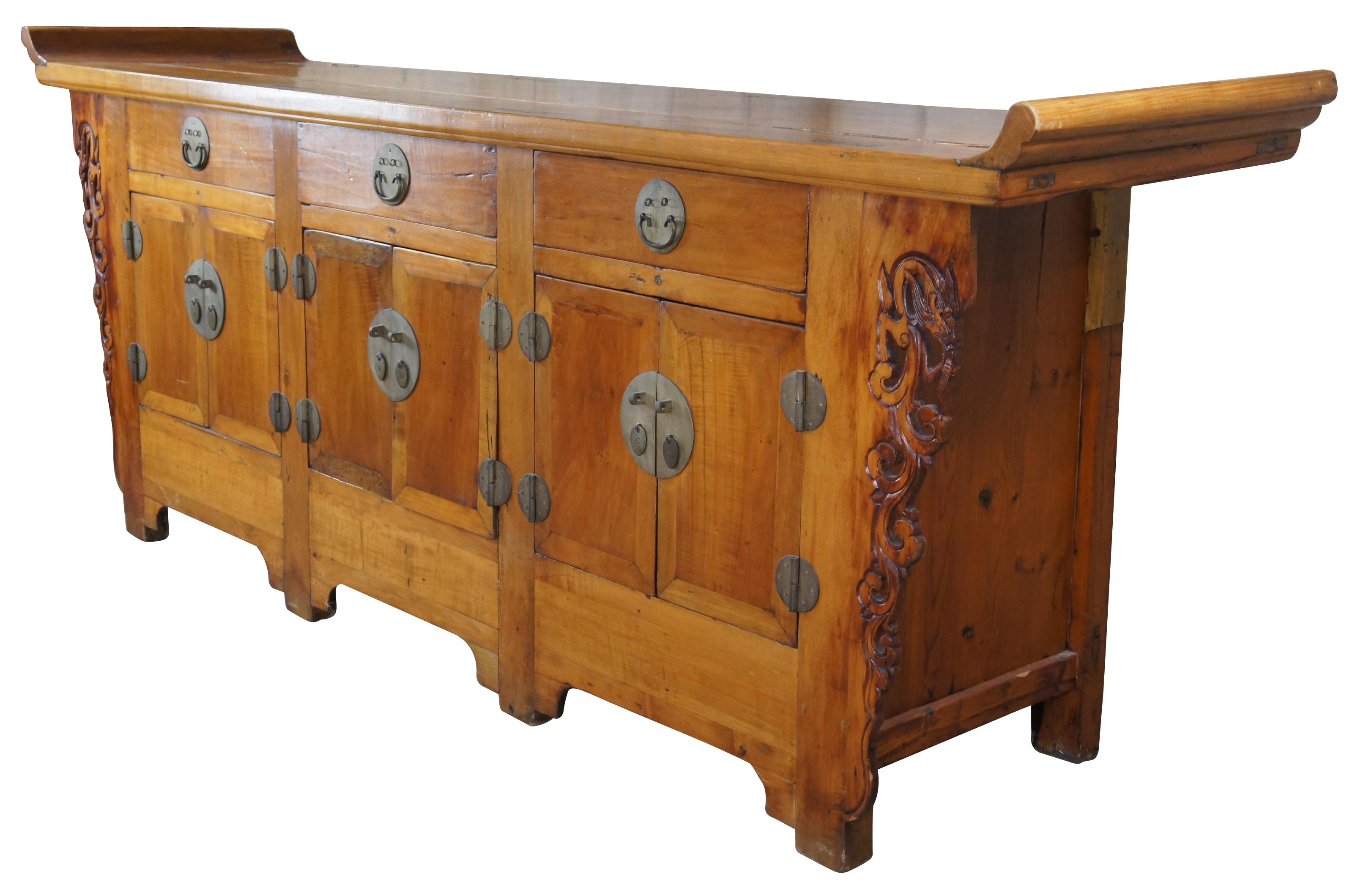 A very large and impressive Chinese Qing Dynasty three door altar coffer, sideboard or credenza, circa 1870s. Made from elm in mortise and tenon construction with dovetailed drawers over lower cabinets with shelves. Features carved and pierced