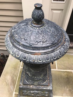 Monumental Antique Covered Cast Iron Urns on Plinths and Lion Head Handles, Pair
