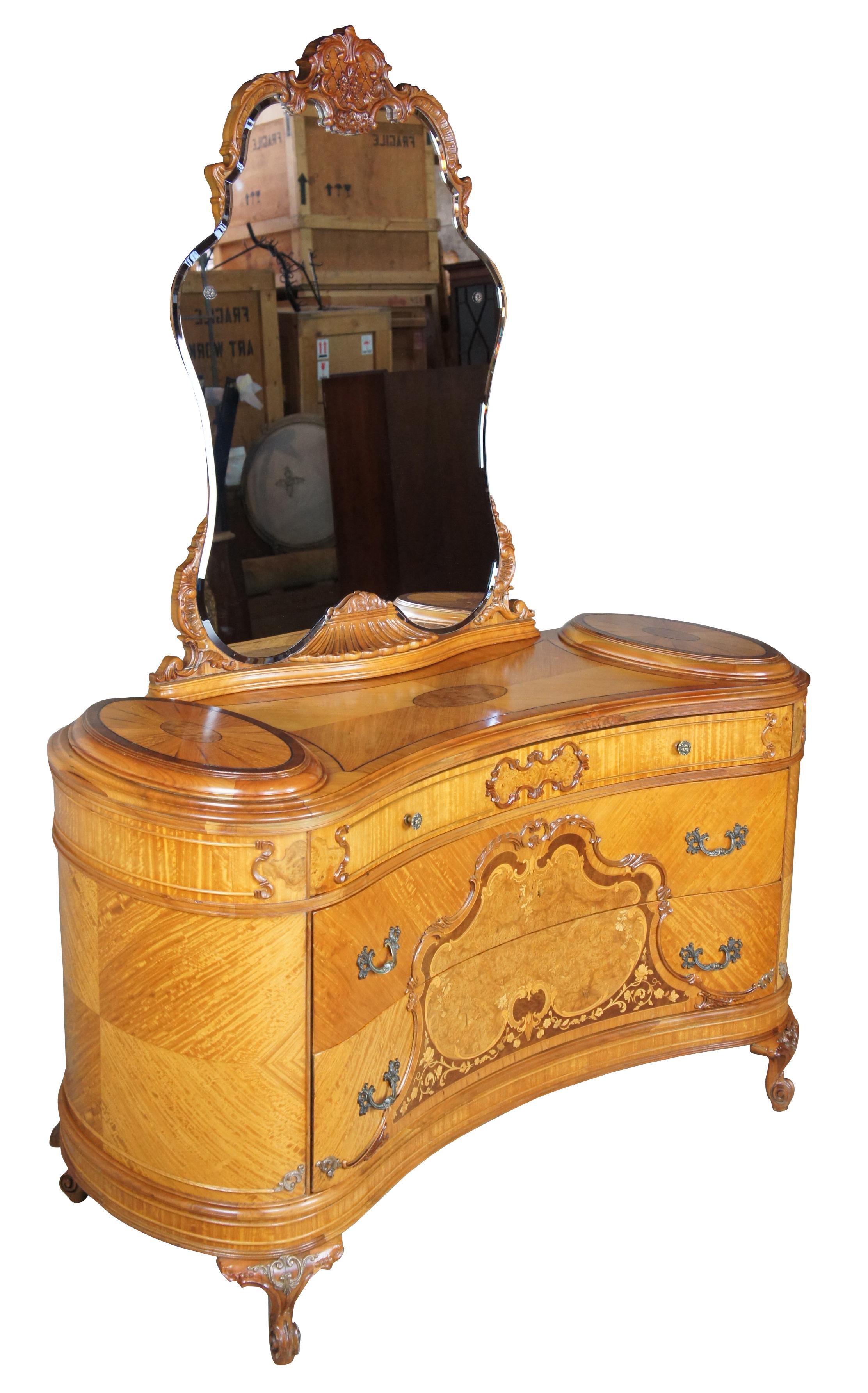 French dresser and mirror, circa 1920s. Features a curved shape with matchbook veneering and burled accents. Made from walnut, ornately carved. Includes three drawers, and cabriole scrolled feet.
  
Surface Height - 34.5