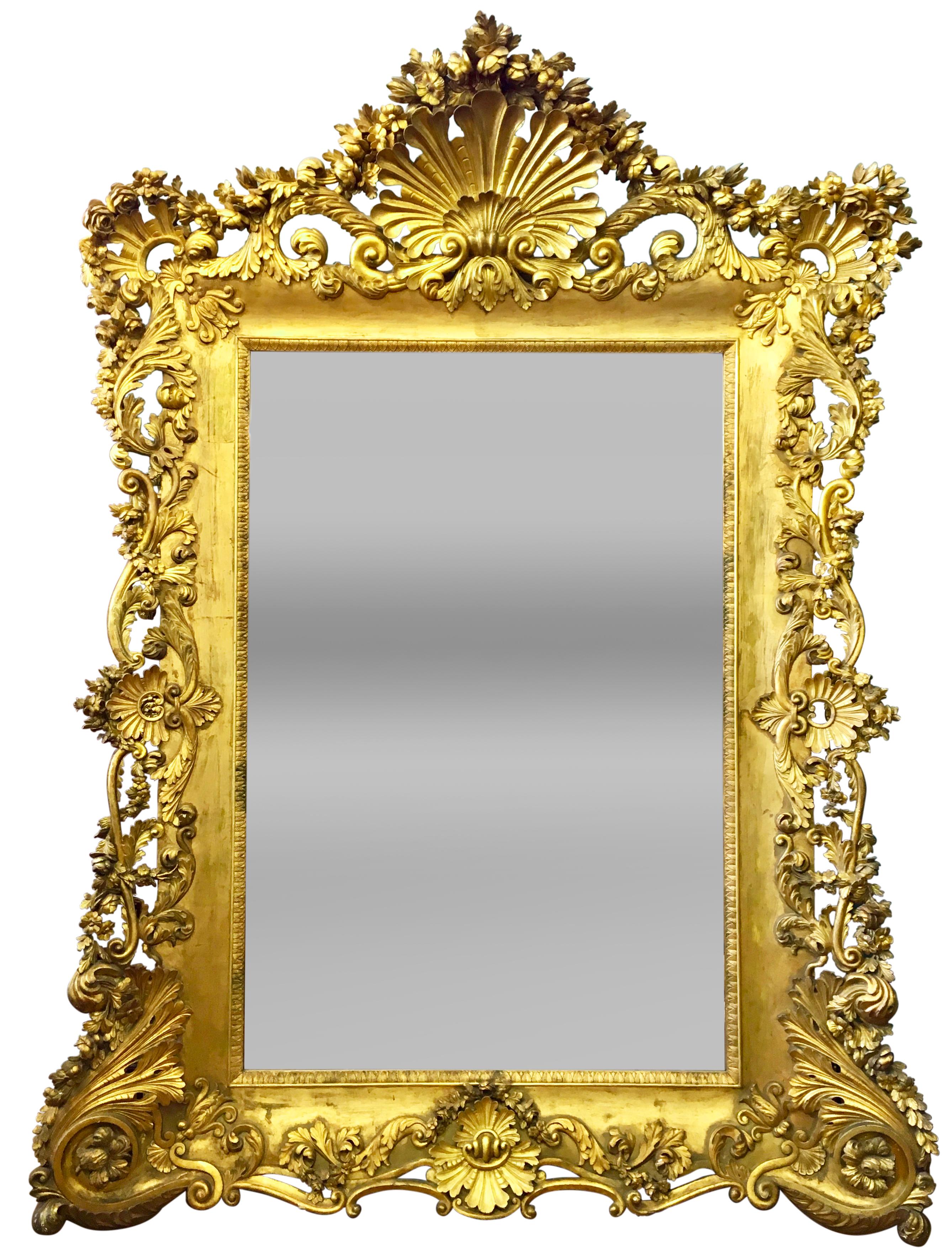 A PALATIAL LOUIS XV STYLE FRENCH CARVED RECTANGULAR GILT-WOOD MIRROR

France, Circa 1880.

This mirror is an absolute masterpiece, a testament to the craftsmanship of artisans. Every inch is adorned with intricately carved garlands of delicate