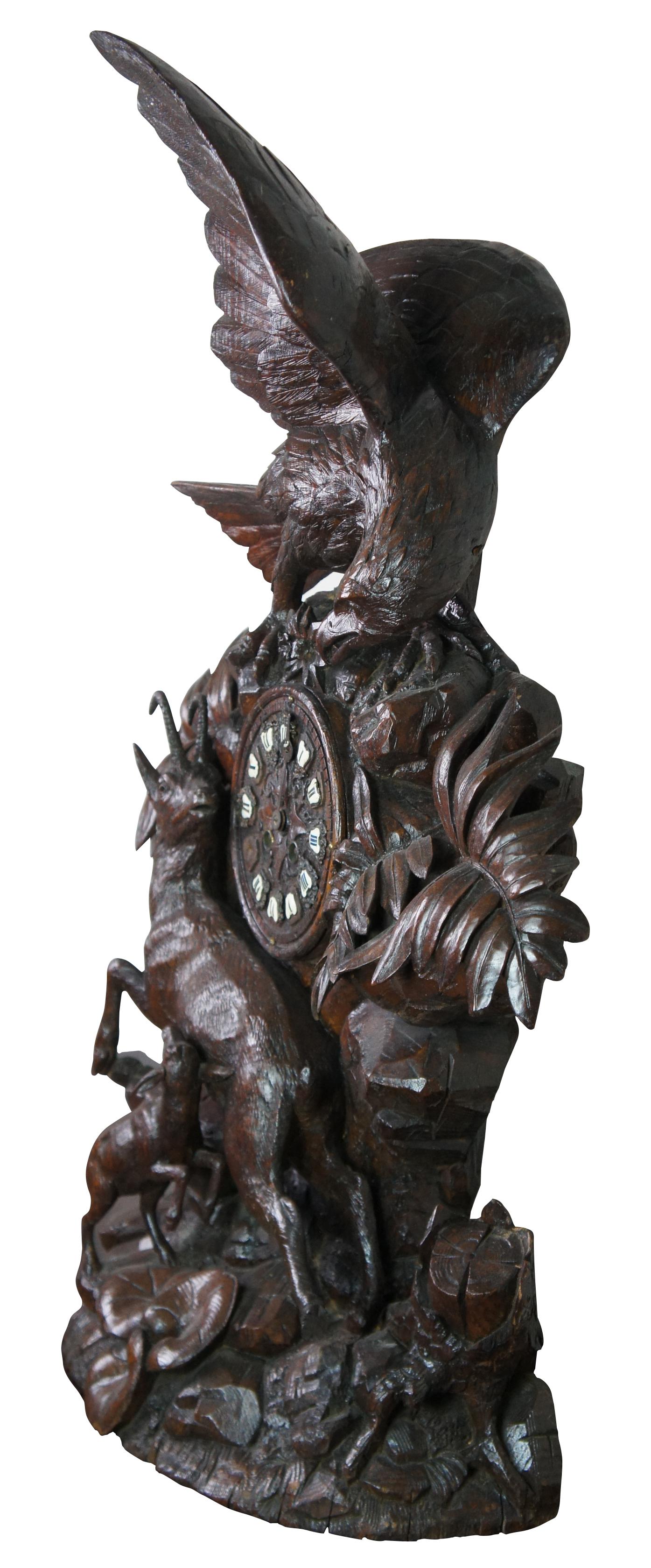 Monumental 19th century antique German Black Forest mantel clock featuring carved high relief details with a winged bald eagle mounted atop foliage hunting a Chamois mountain antelope / goat and her baby.

Black Forest clock production started in