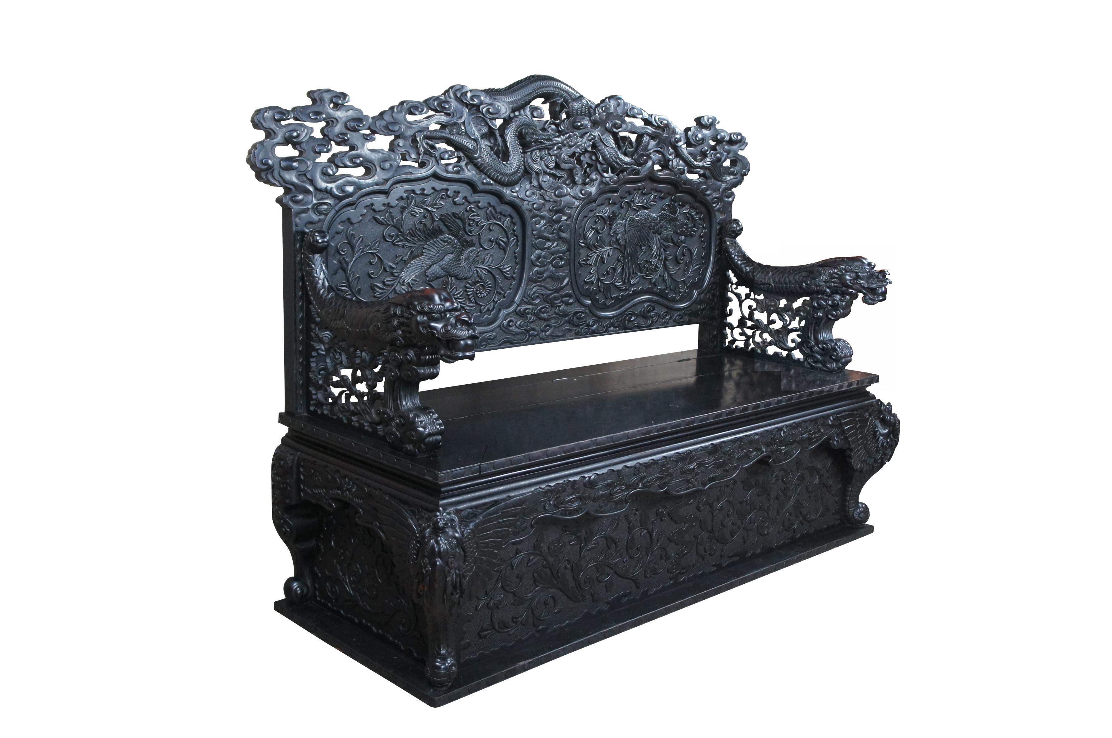 Impressive Imperial Japanese Meiji period Elm Dragon storage bench. Features high relief carved accents and under seat storage. From top to bottom this piece is adorned with three toed dragons. The crown is pierced with a serpentine dragon sprawling