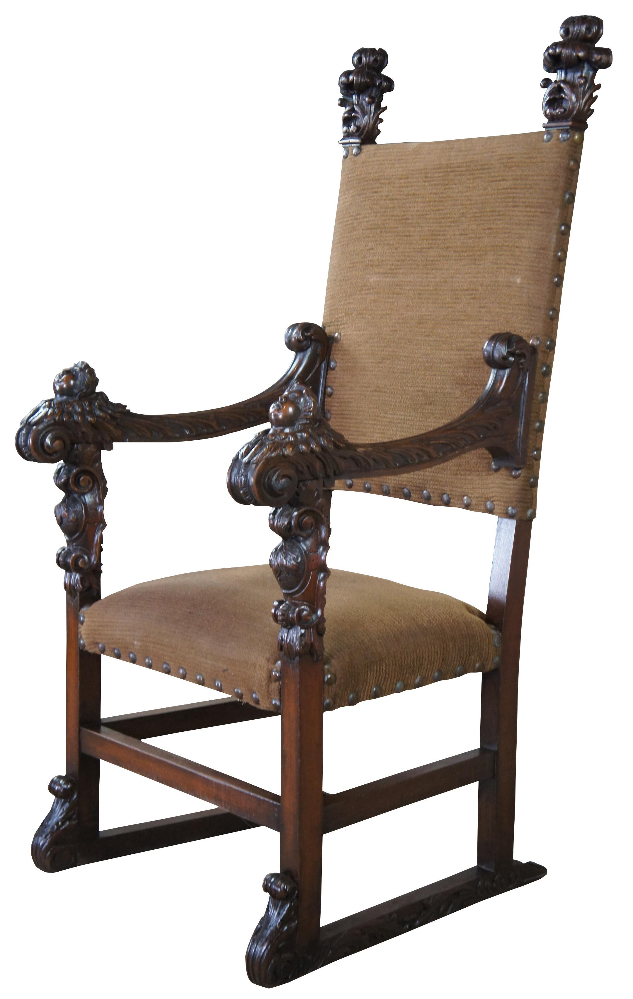 Monumental 19th century Italian Renaissance old world throne chair. Made from oak with meticulously caved detail. Features scrolled arms topped with figural cherubs and acanthus leaves. Upholstered in beige with button tufting.
  