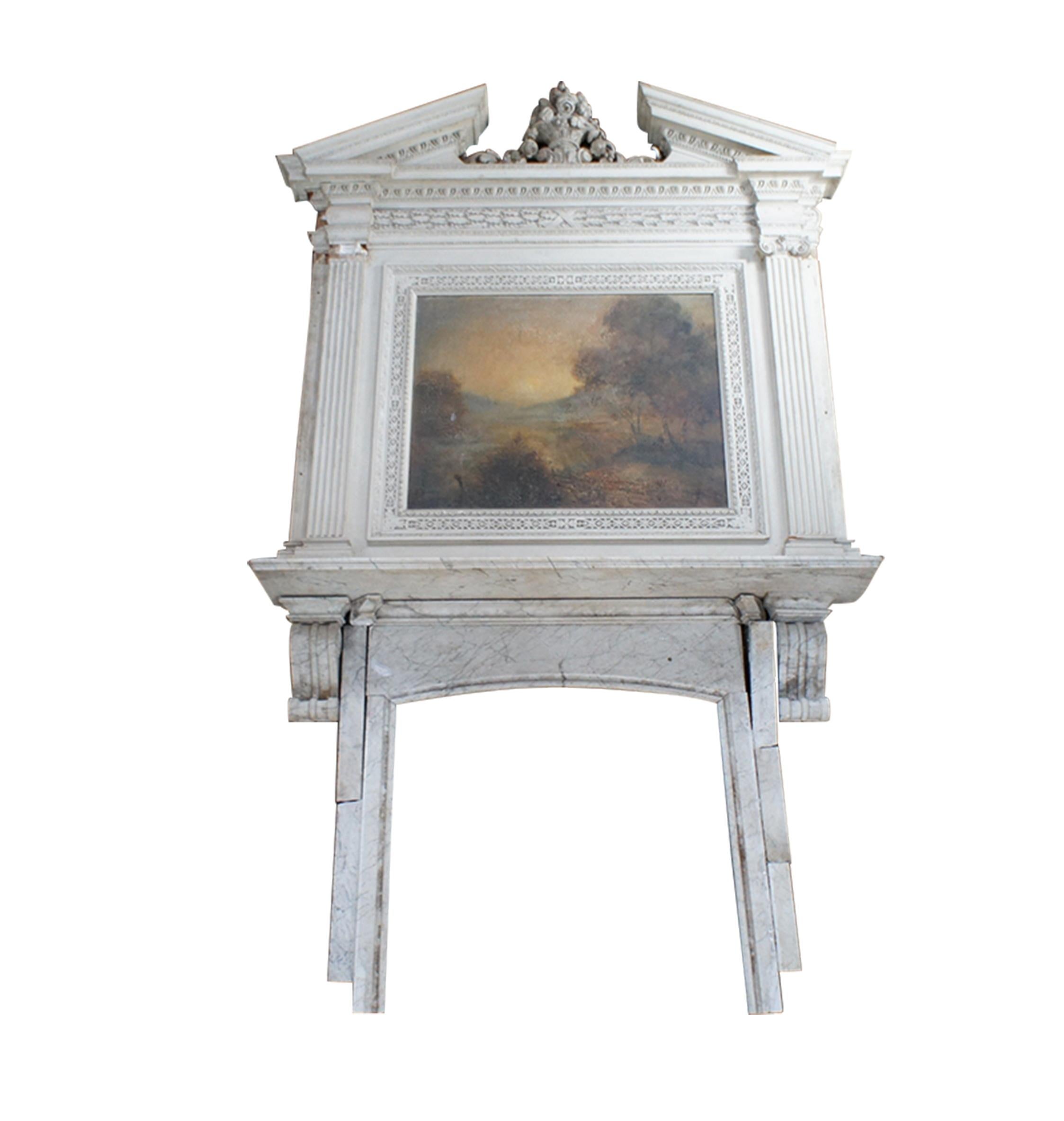 A very large and impressive fireplace mantel with Neoclassical and Grecian styling that features an impressive carved over mantel with open pediment design and ornate flower urn with acanthus accents.  Features fluted columns, egg and dart molding,