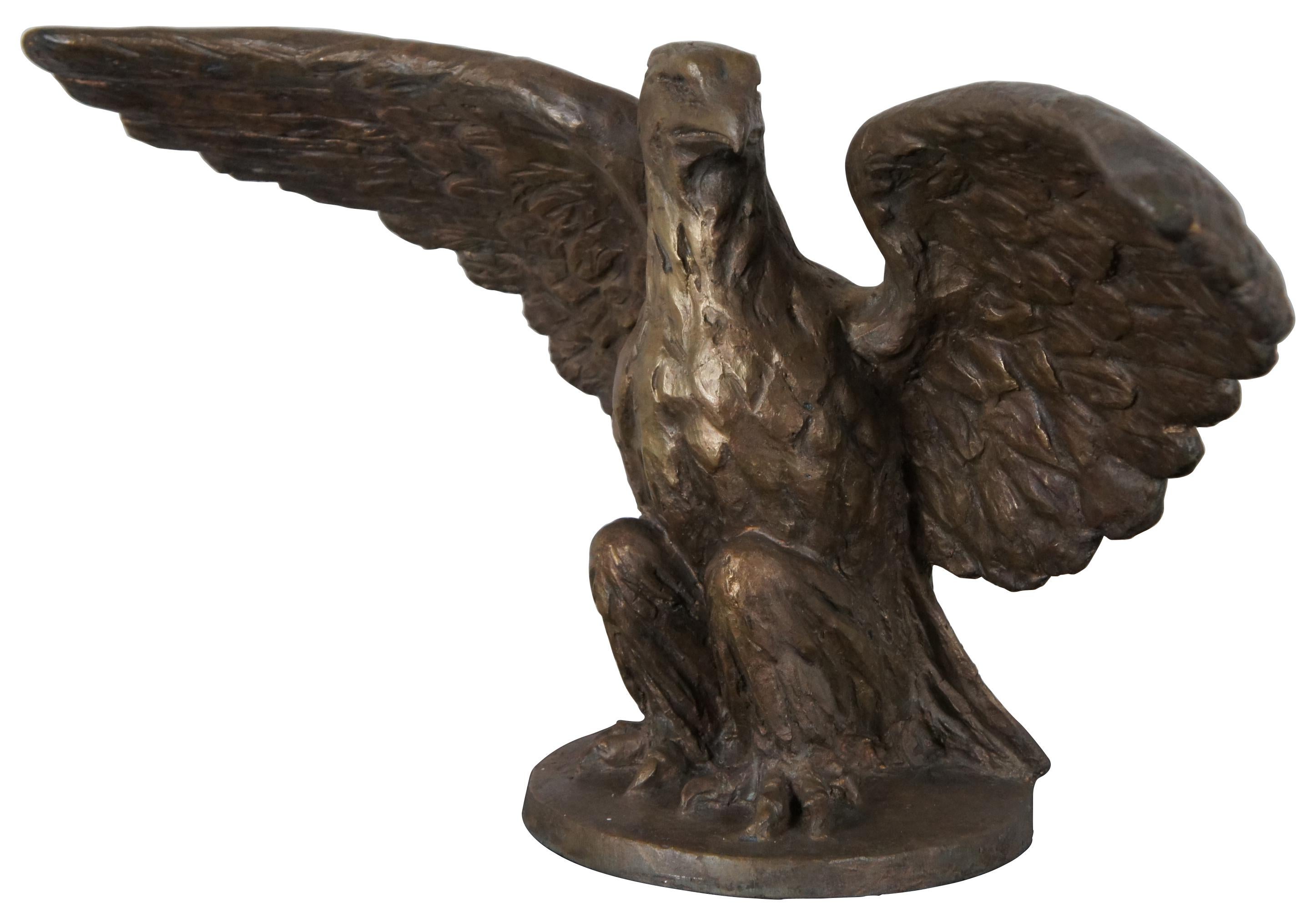 Museum quality antique solid bronze 70lb sculpture by Roman Bronze Works of an eagle seated on the base with wings outstretched. Roman Bronze Works, now operated as Roman Bronze Studios, is a bronze foundry in New York City. Established in 1897 by