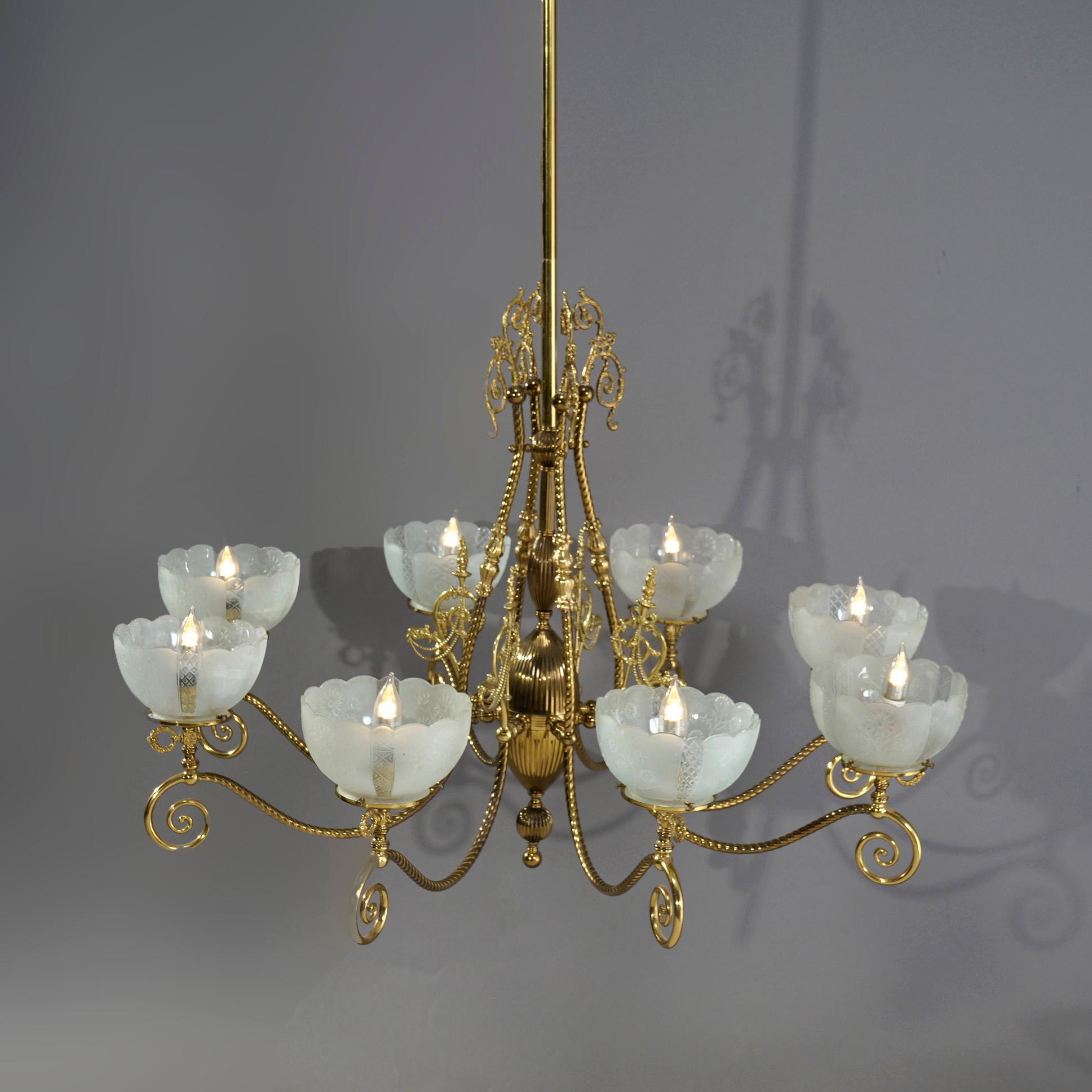An antique and large Victorian electrified gas chandelier offers brass frame with rope twist shaft having six scroll form arms with foliate elements terminating in etched glass shades (non-matching), c1890

Measures- 82.5''H x 43''W x