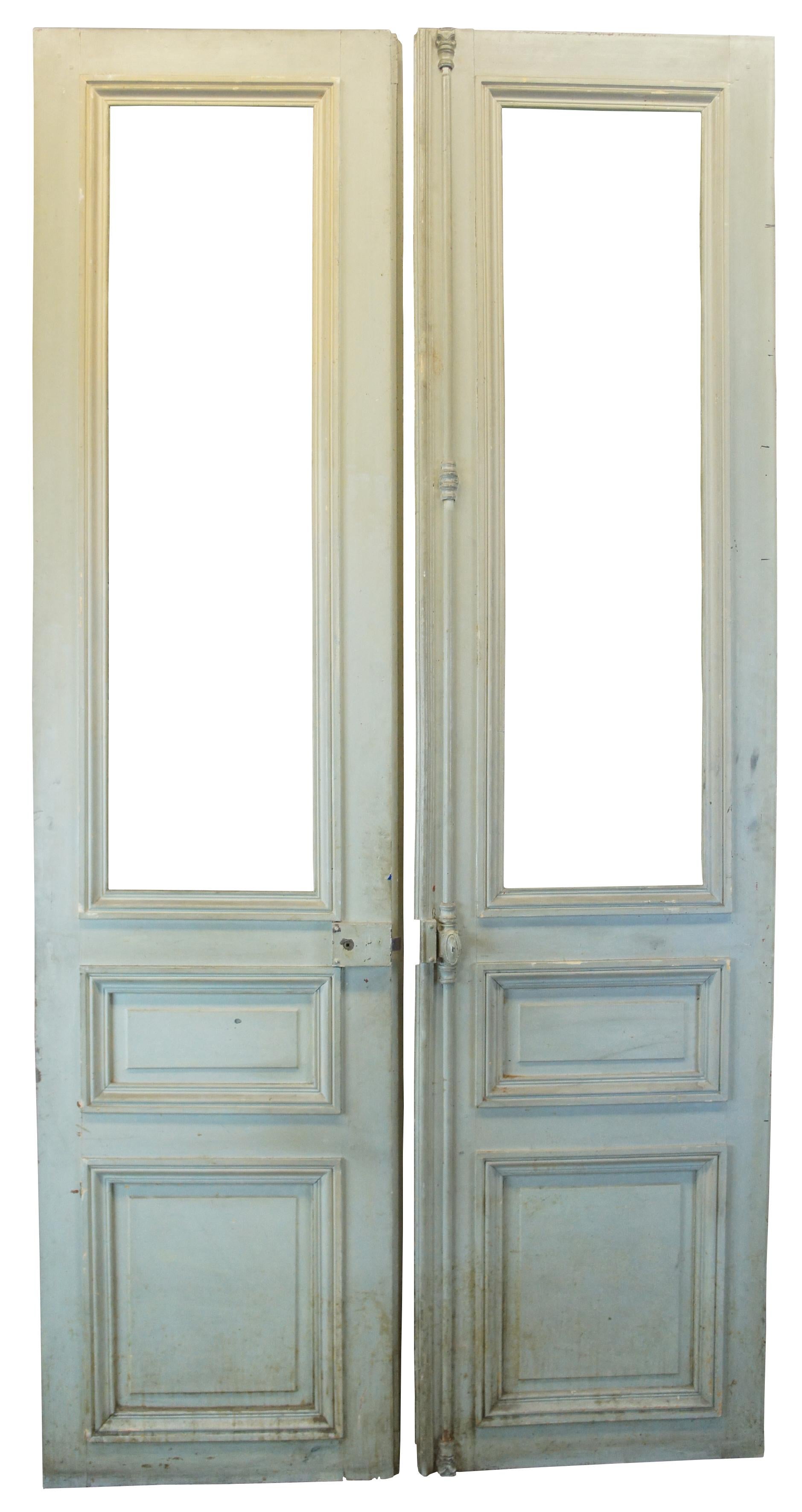 Monumental late Victorian French double doors featuring paneling on both sides and an iron cremone bolt lock hardware.

Measures: 55