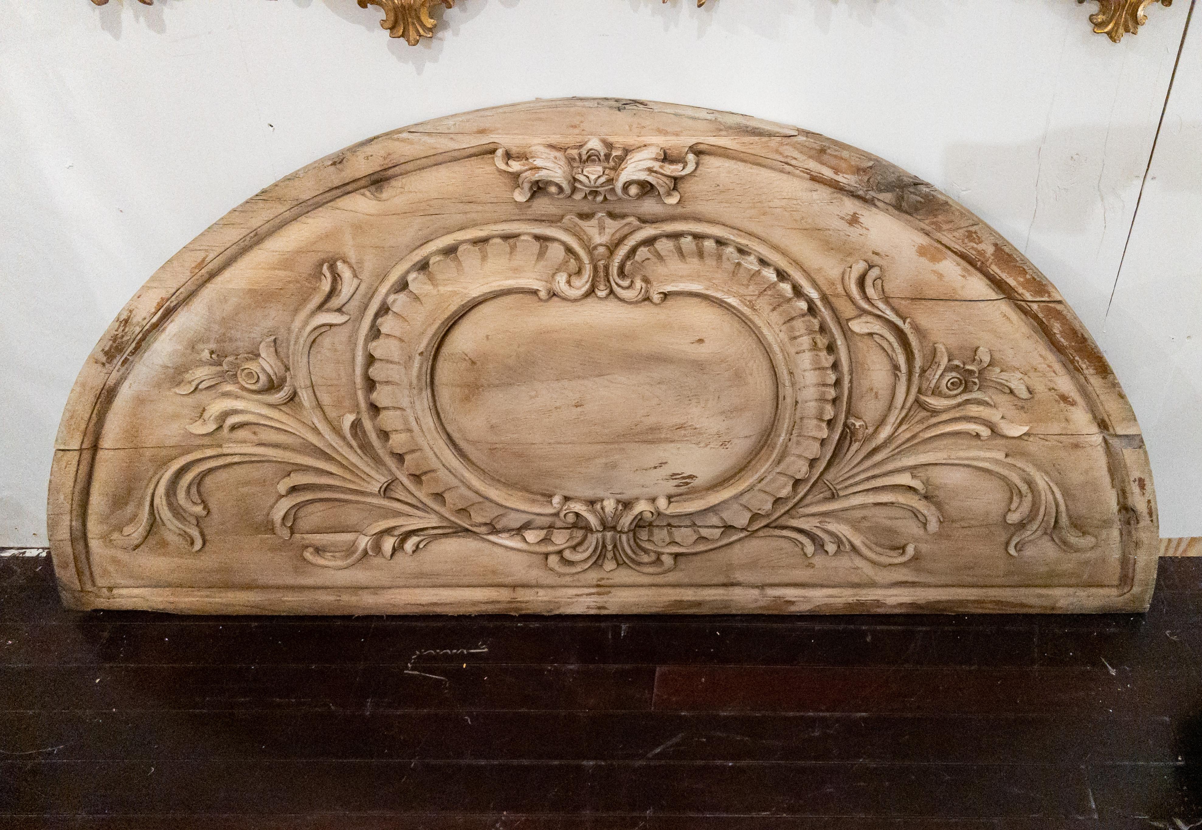 Monumental Arched Wood Architectural Fragment with Carvings from France. The wood has a bleached appearance. This piece could be used as a head board or to add architectural detail to a space.