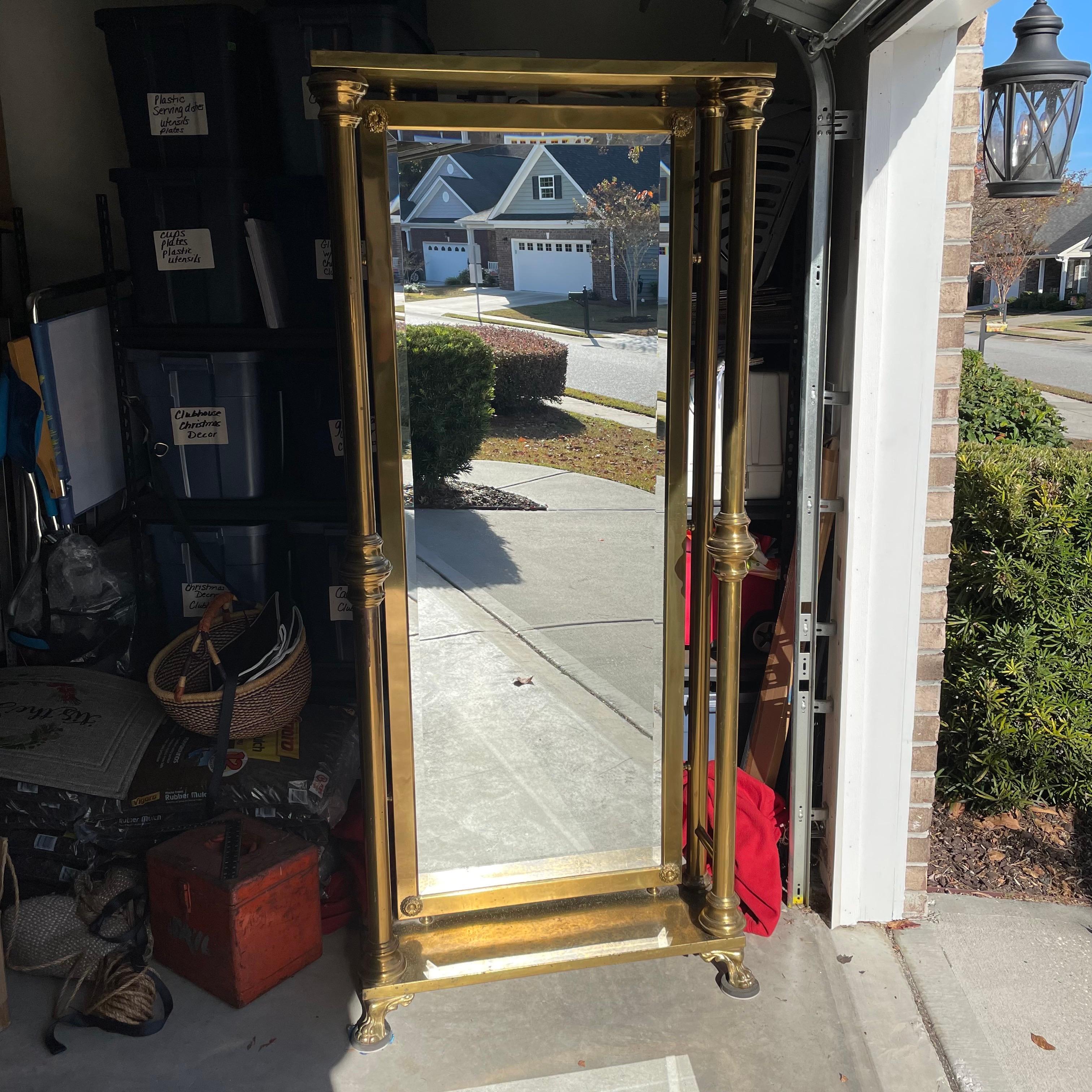 This free standing Art Deco brass floor mirror is quite the statement piece. The back is a sheet of wood to keep the mirror in place. You will not find another mirror like this! It is structurally sound with no wobbliness. The mirror is reinforced