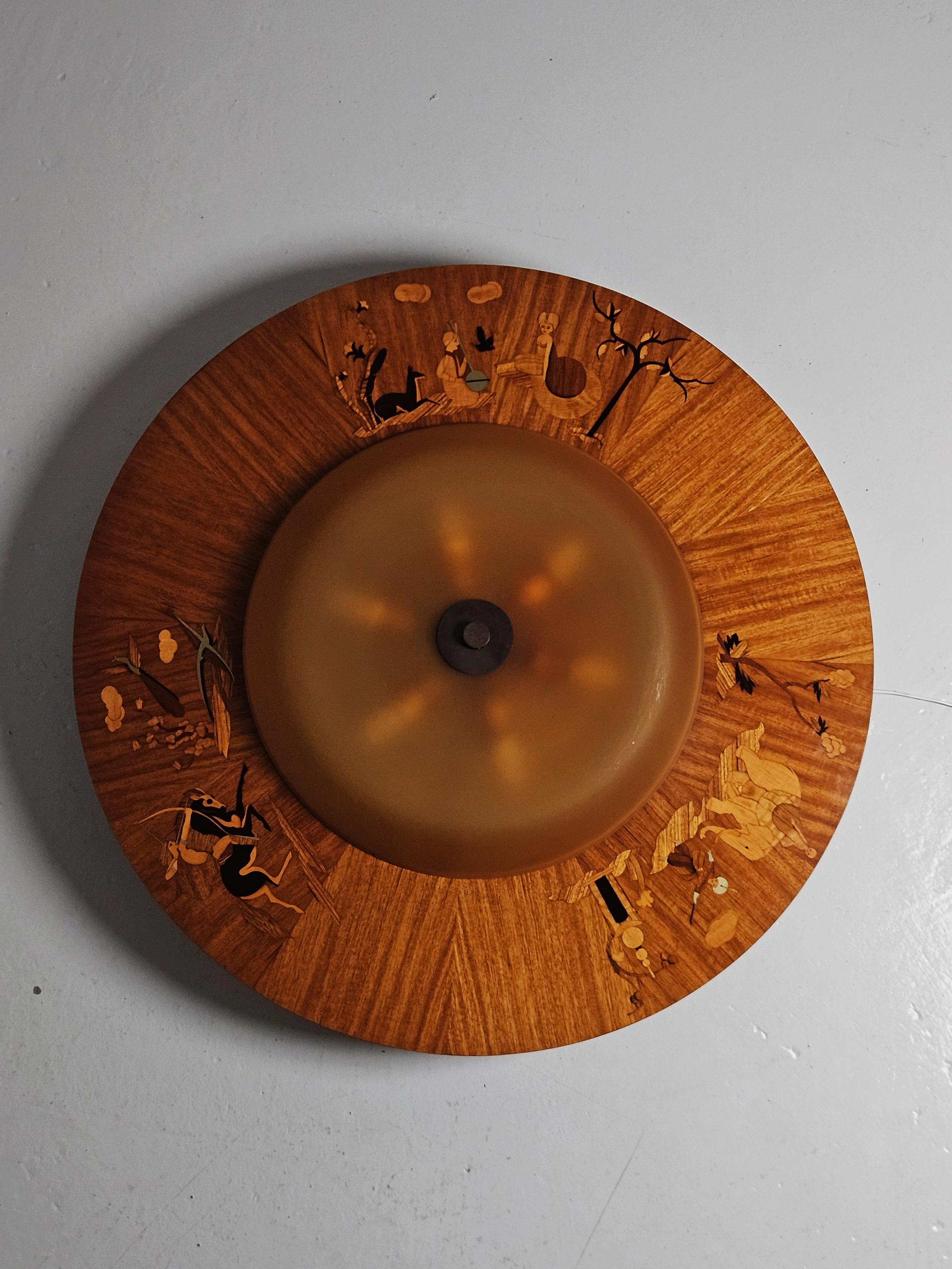 Impressive flush mount ceiling lamp designed by Birger Ekman for Mjölby Intarsia during the 1930s. 

Very rare in this monumental size. Beautiful wood inlays with a large amber colored glass. 

Small chip missing from glass. 