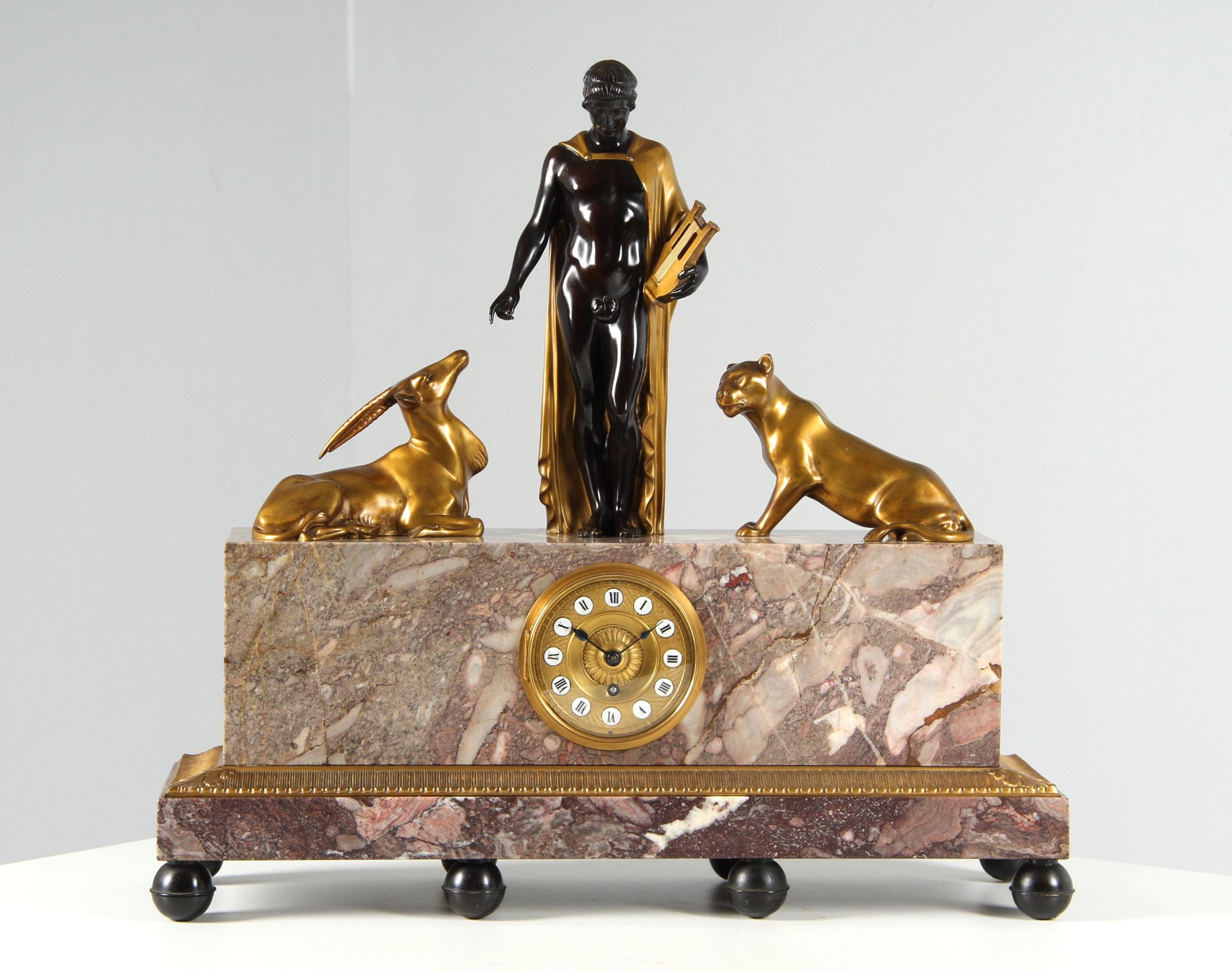 Monumental Art Deco clock - Orpheus and the animals

Austria
Bronze, marble
Art Deco around 1925

Dimensions: H x W x D: 56 x 60 x 19 cm

Description:
The protruding base, which stands on eight ball feet, supports the solid marble block with the
