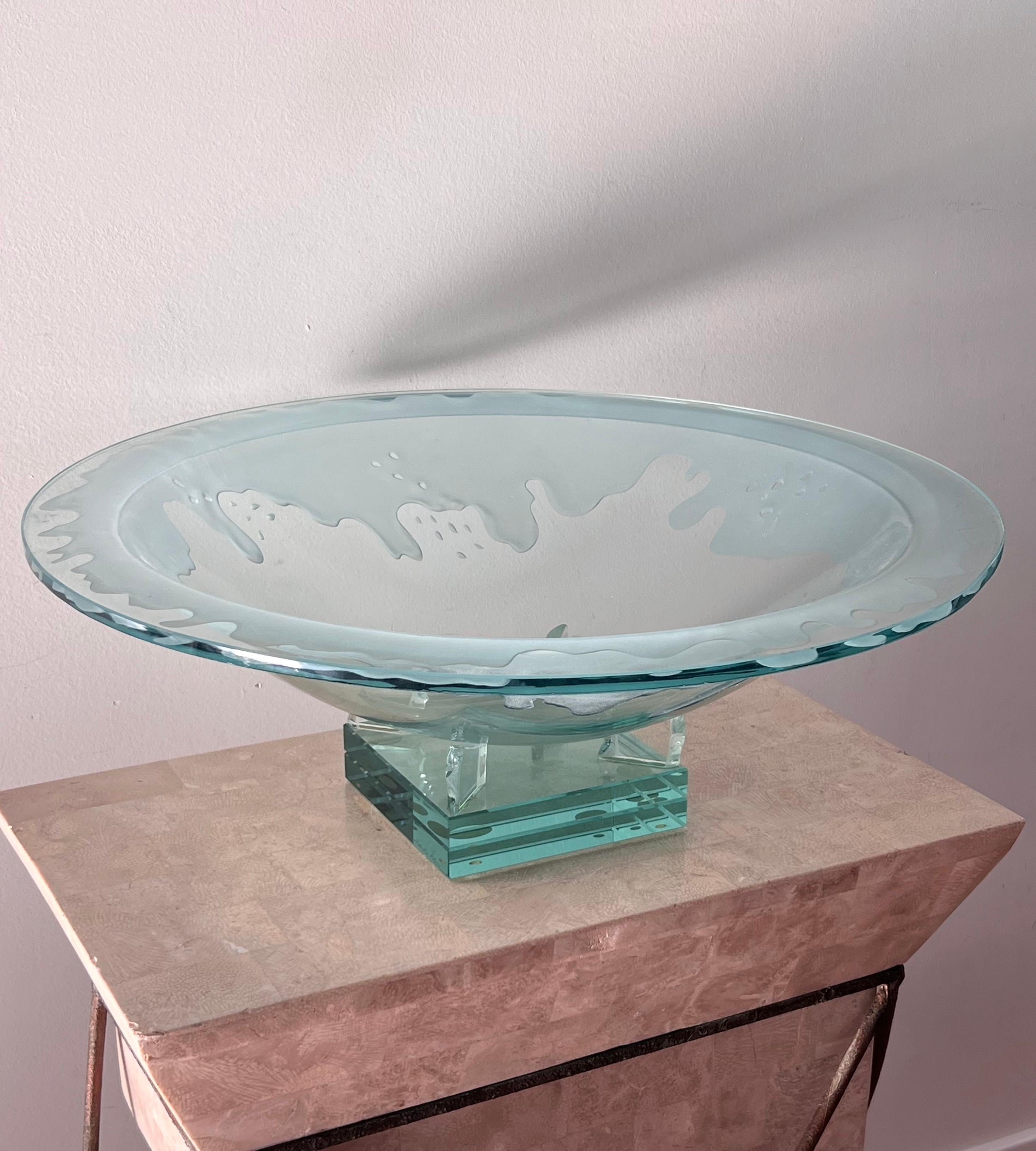 An impressive and monumental art glass bowl, late 20th century. Featuring frosted glass in a “dripping liquid” motif. Platter sits atop a stacked art glass plinth. Light scratches but no chips or losses. Pick up in central west Los Angeles or we