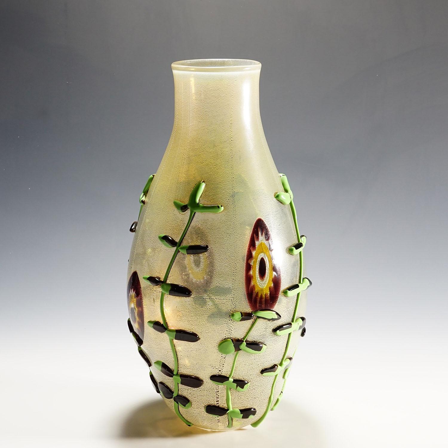 Monumental Art Glass Vase by Licio Zanetti, Murano, circa 1970s

A large art glass vase handmade by glass master Licio Zanetti, circa 1970s for Zanetti Murano SRL. Free formed clear glass body decorated with melted blossoms and craceled gold foil