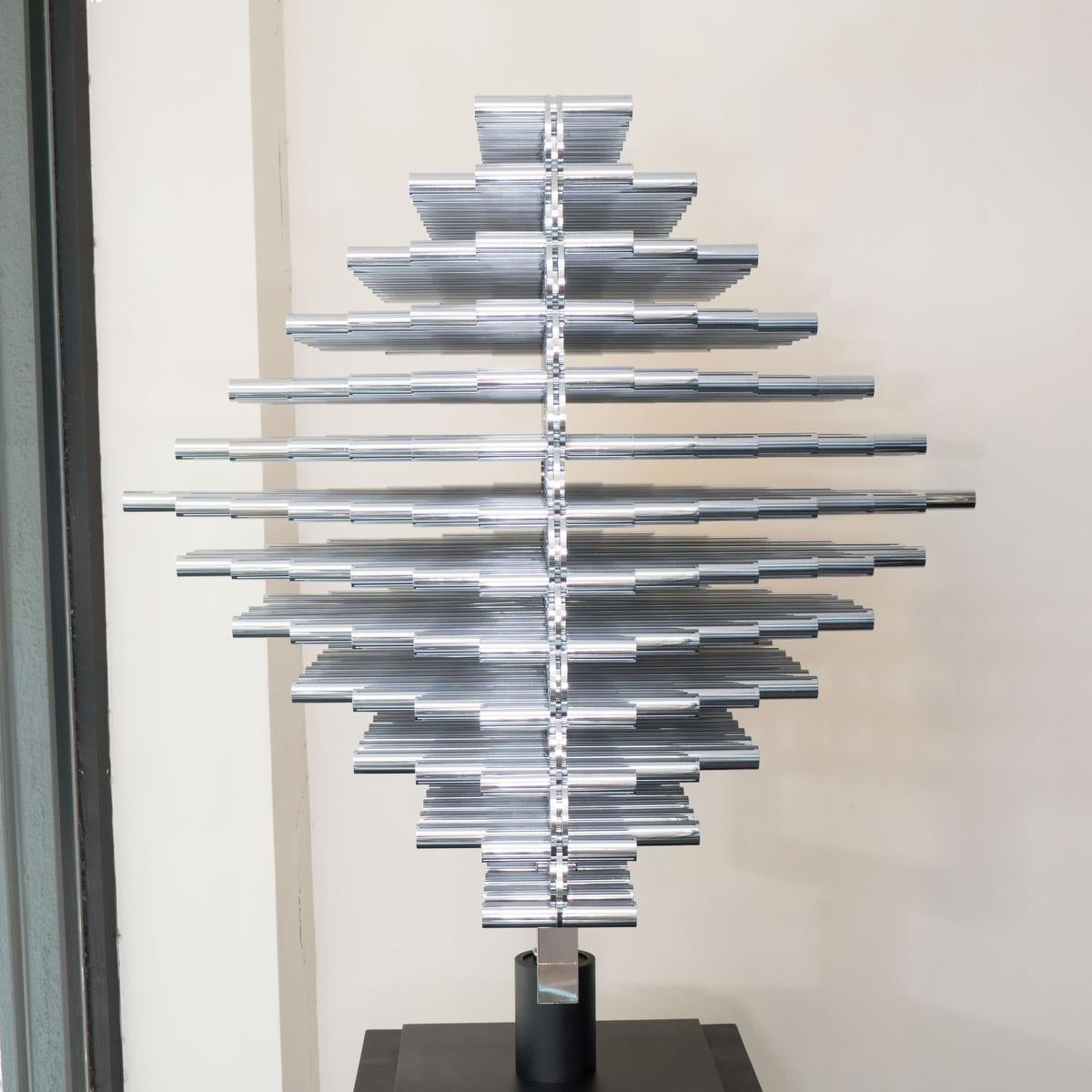 Monumental articulated stainless steel rod modern sculpture on a black metal base by Giuseppe Minoretti.