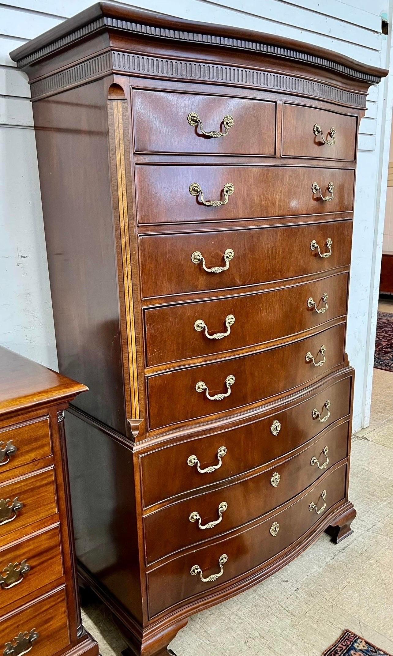 Magnificent tall and large nine drawer Baker Furniture gentleman's chest of drawers done in the finest mahogany and brass.  All original.  Note the dimensions, this piece stands almost six feet tall and has a gorgeous inlay at sides.  One piece
