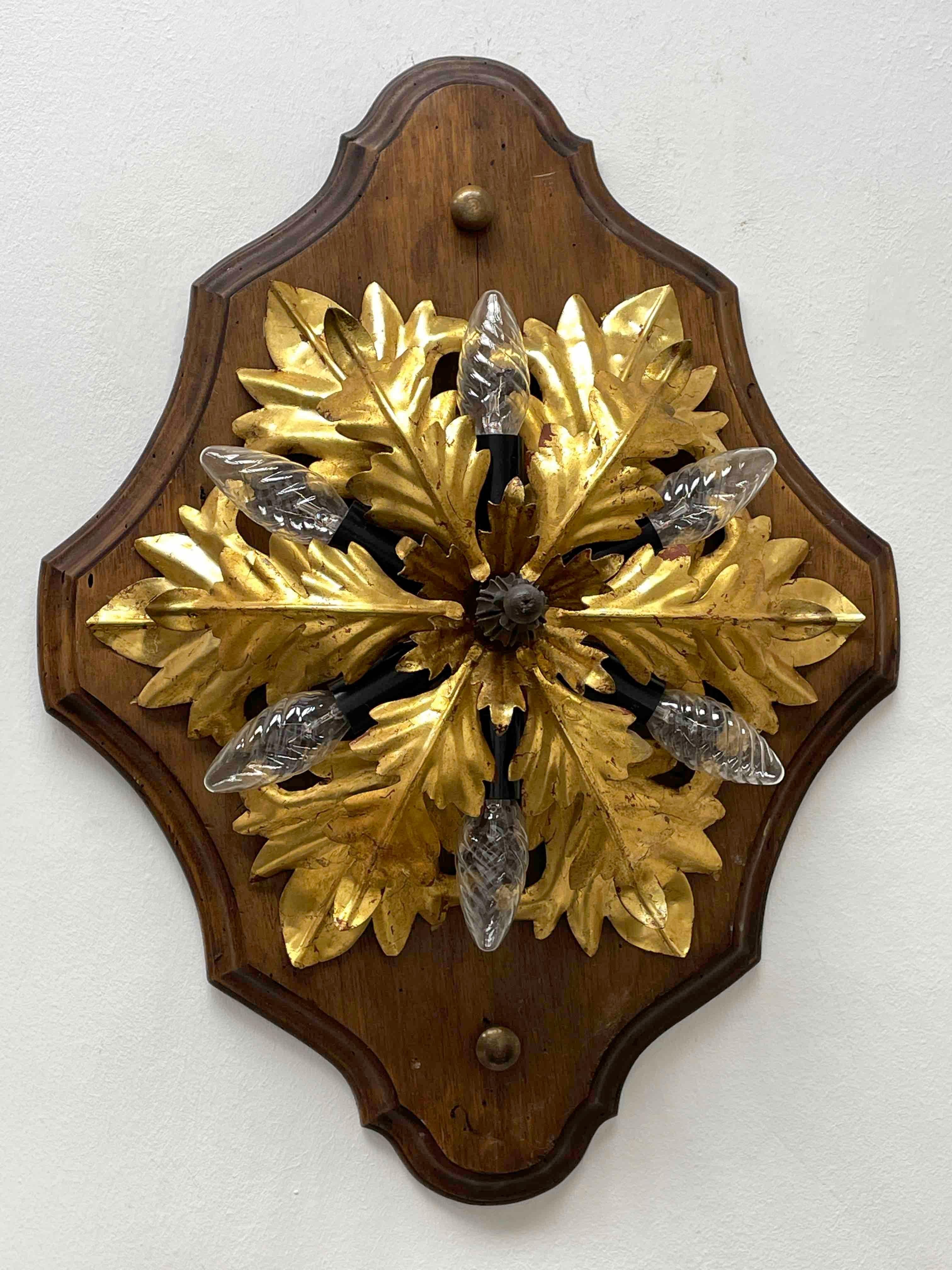 Add a touch of opulence to your home with this charming flush mount light. Perfect stunning gilt acanthus leaf design with a large wooden back, to enhance any chic or eclectic home. We'd love to see it hanging in an entryway as a charming welcome