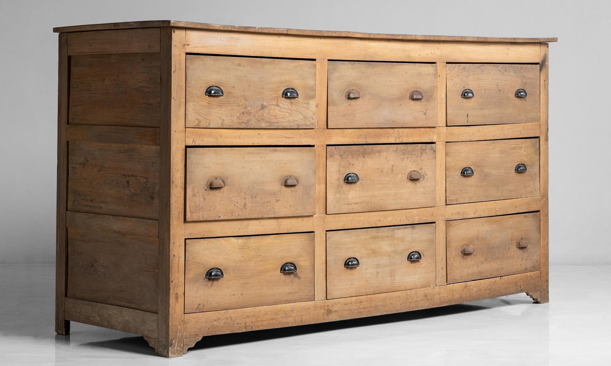 Substantial Series of nine oak fronted drawers with pine lining, and paneled pine sides and back boards.