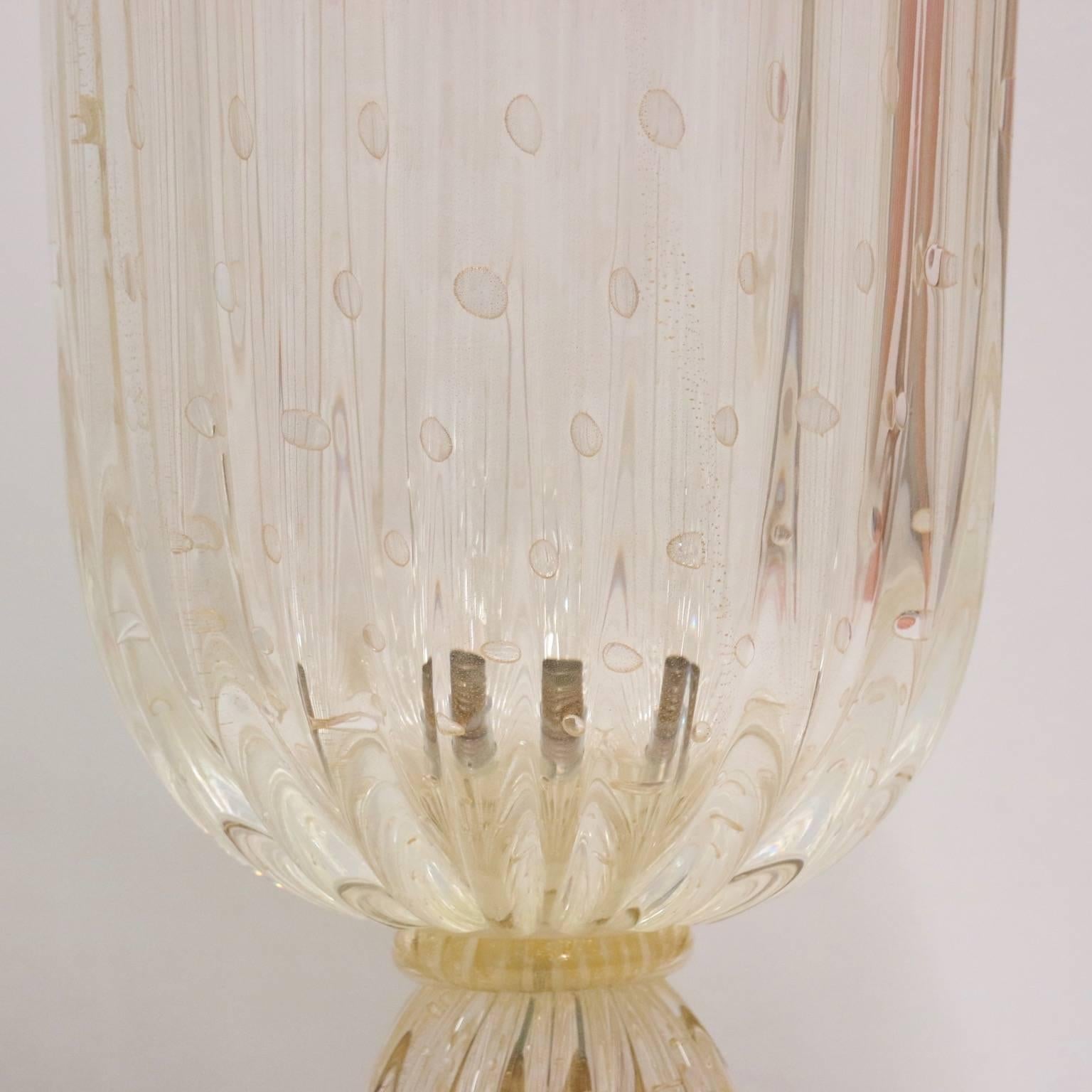Hollywood Regency Murano glass urn-shaped lamps with controlled bubble technique and infused with gold flakes by Barovier. These lamps are large and very heavy. 

Each has been fully restored with new wiring and takes a standard light bulb. The