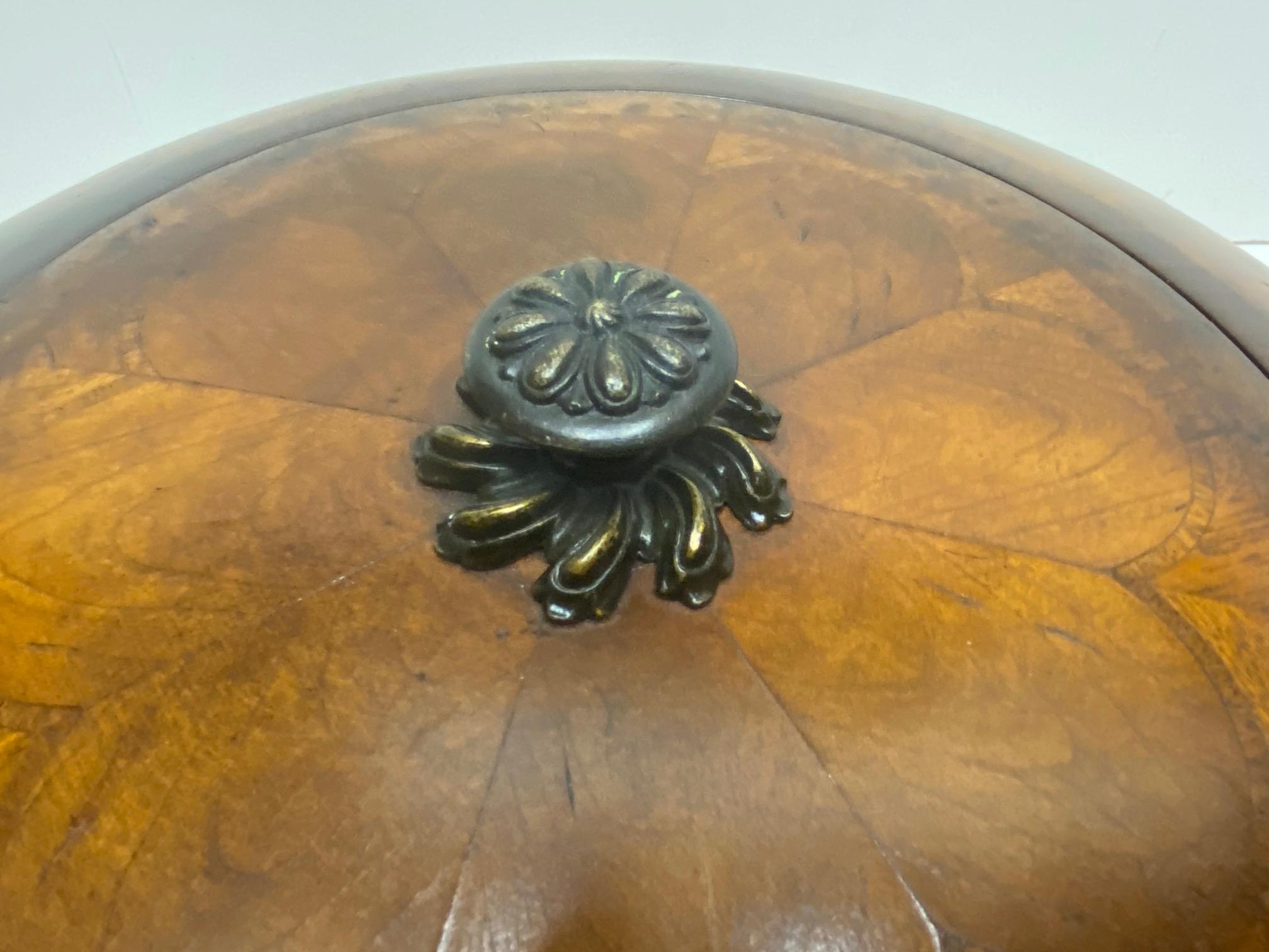 Very large impressive rounded wooden box having beautiful inlay design on the top with gorgeous brass knob.
Opening is 10