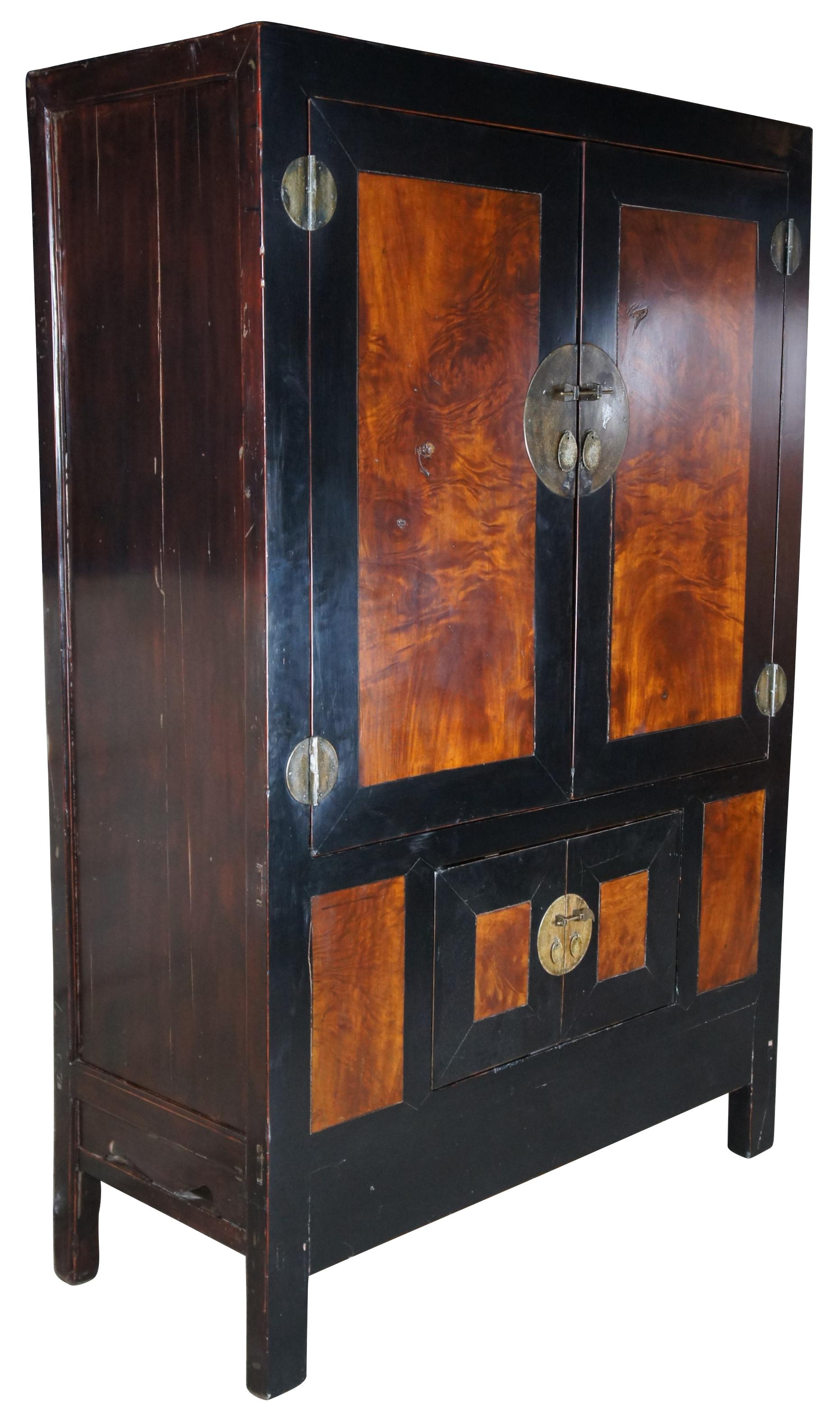 An impressive 20th century Ming Dynasty inspired lacquered elm wedding storage cabinet or wardrobe. Features a large frame finished in black along the front with inset Carpathian elm burl wood panels. The double doors open to two removable shelves