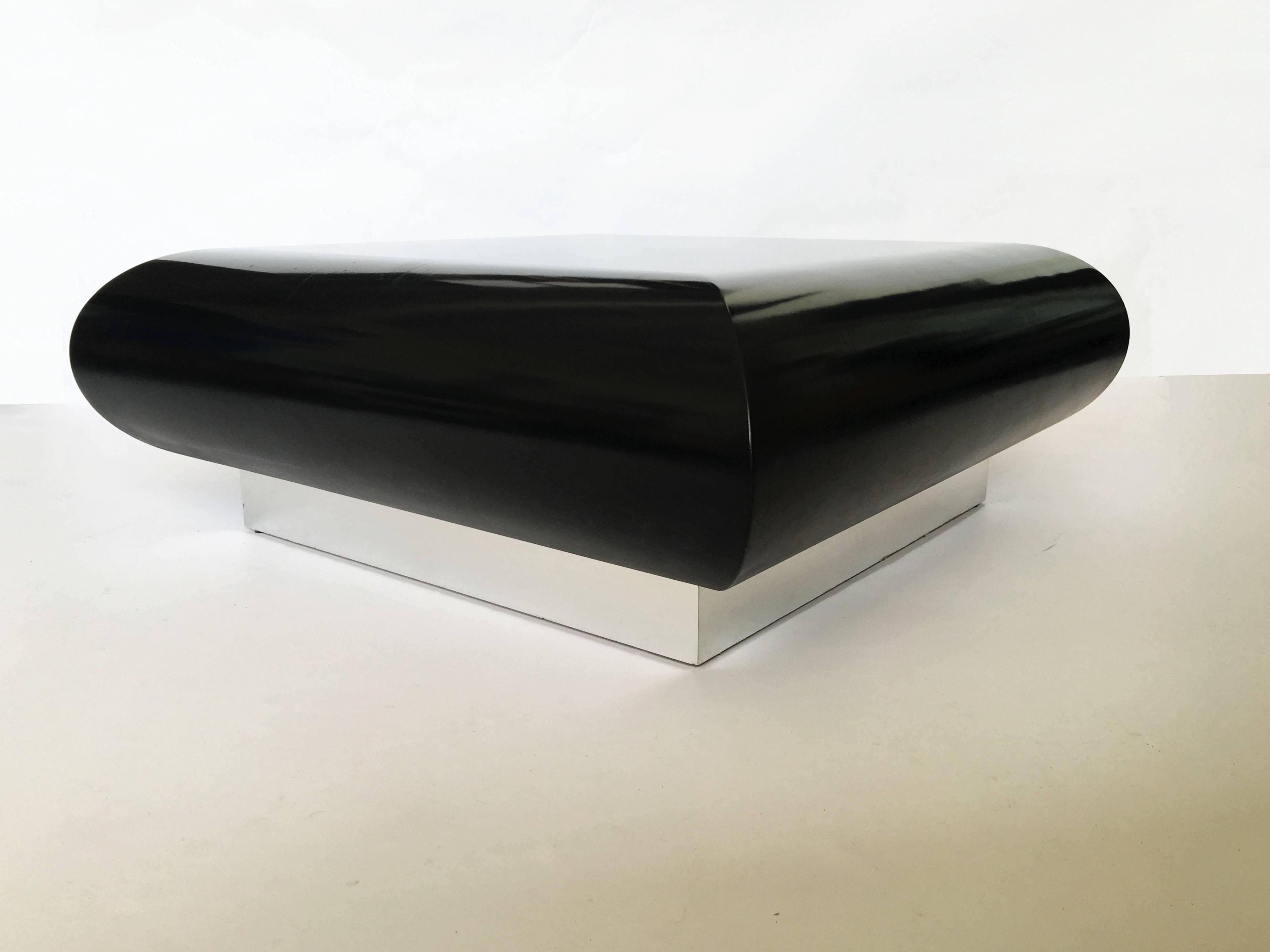 Gorgeous black gloss lacquered pillow freeform low table by Directional. Monolithic and minimal in design. The large square shape with molded convex sides appears to float above the floor on its chrome plinth base. Impeccably constructed.
