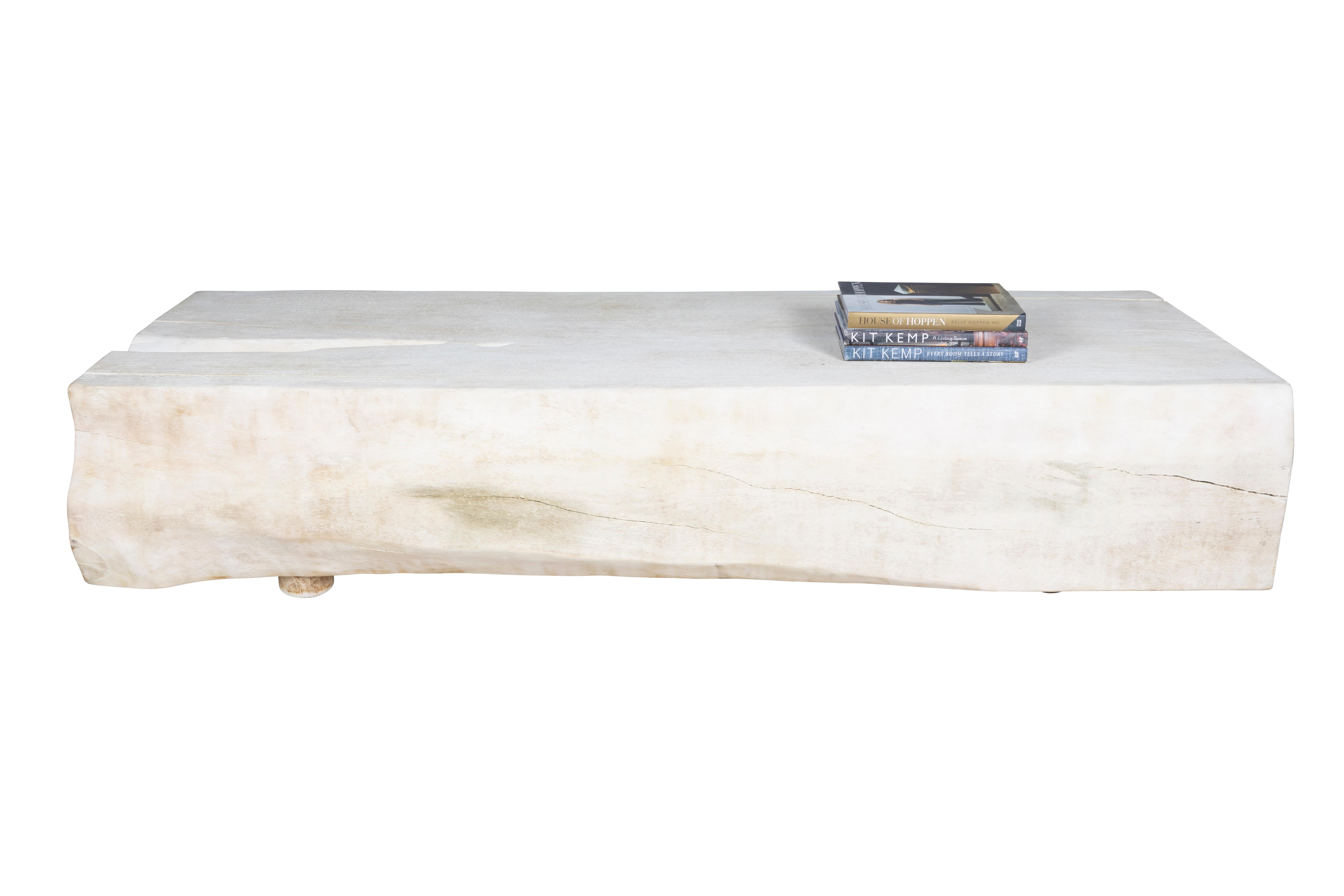 This monumental bleached coffee table is built from one single block of lychee hardwood. The top is flattened, sanded, and then bleached to compliment the wood's naturally rich texture and rustic patterns. The sides are kept in their natural organic