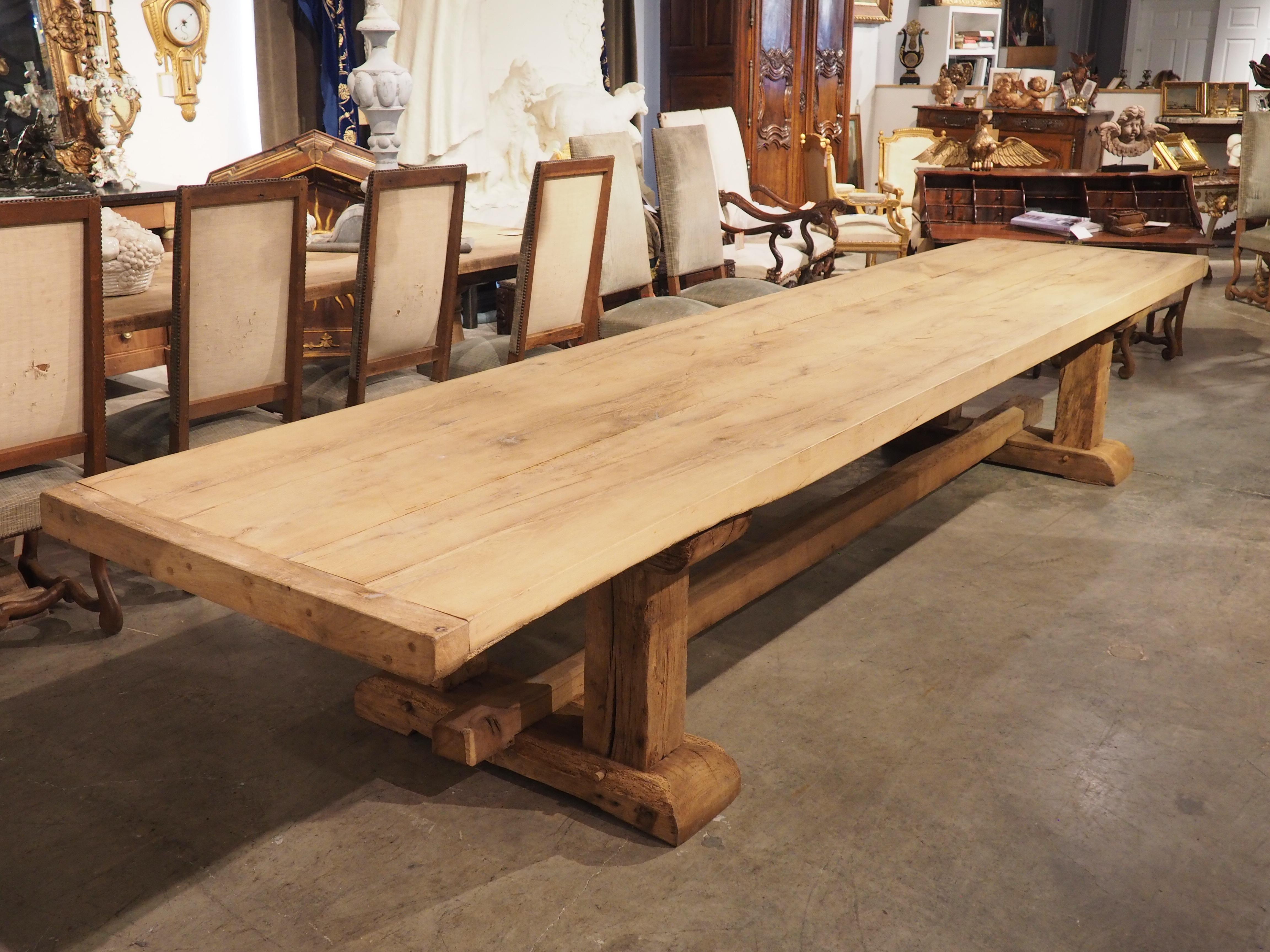 A monumental dining table, measuring over 14 ¾ feet long, the oak wood was hand-carved in France during the early to mid-1900’s. The table has been bleached more recently, allowing all the nuances of the wood grain to become more prominent.

The 3