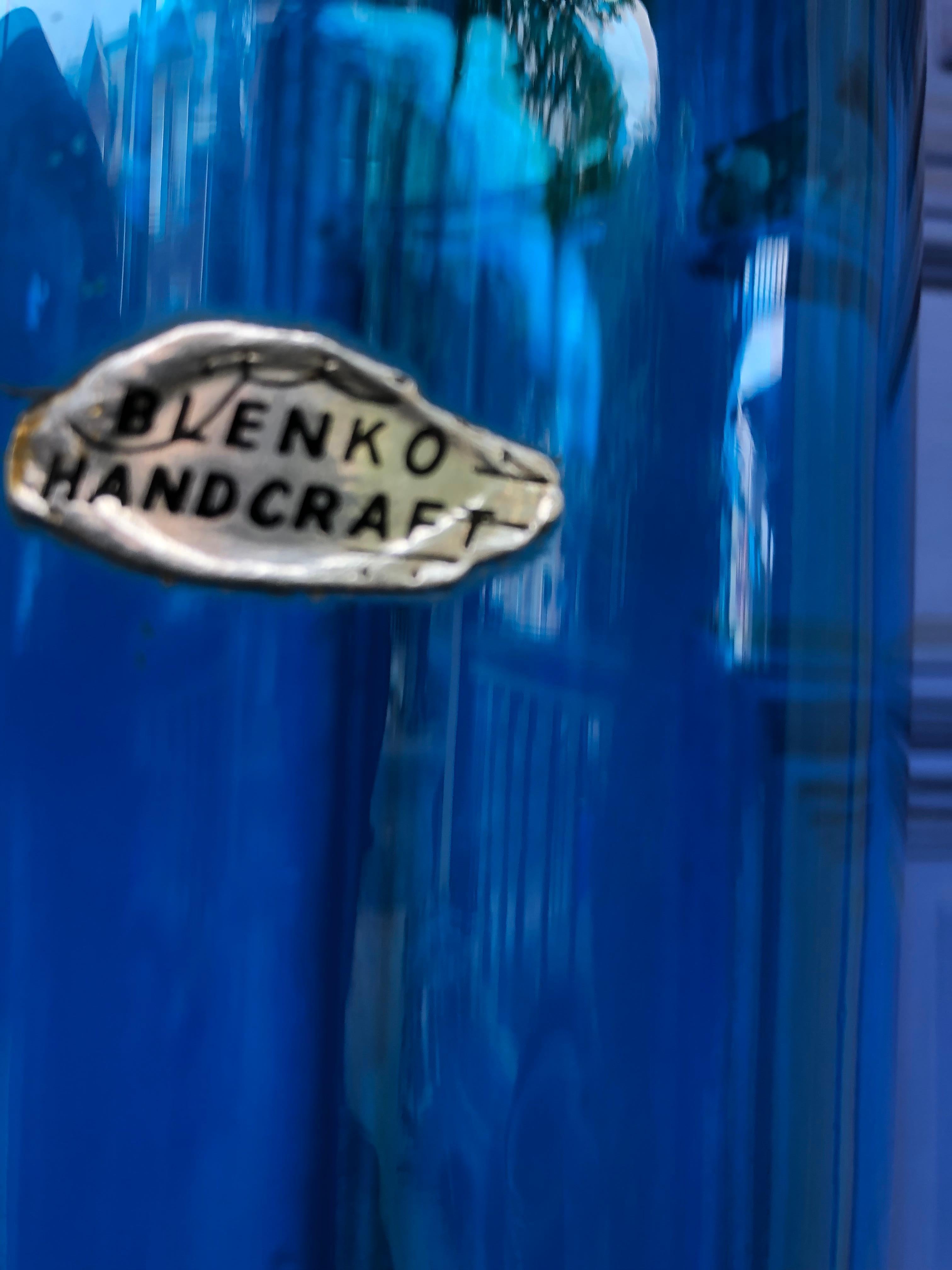 This striking blue Blenko floor vase still bears the original label. Somewhat rare, it is in very good condition with a few scratches on the base(see pictures) and a couple of bubbles which are to be expected. It has no chips or cracks.