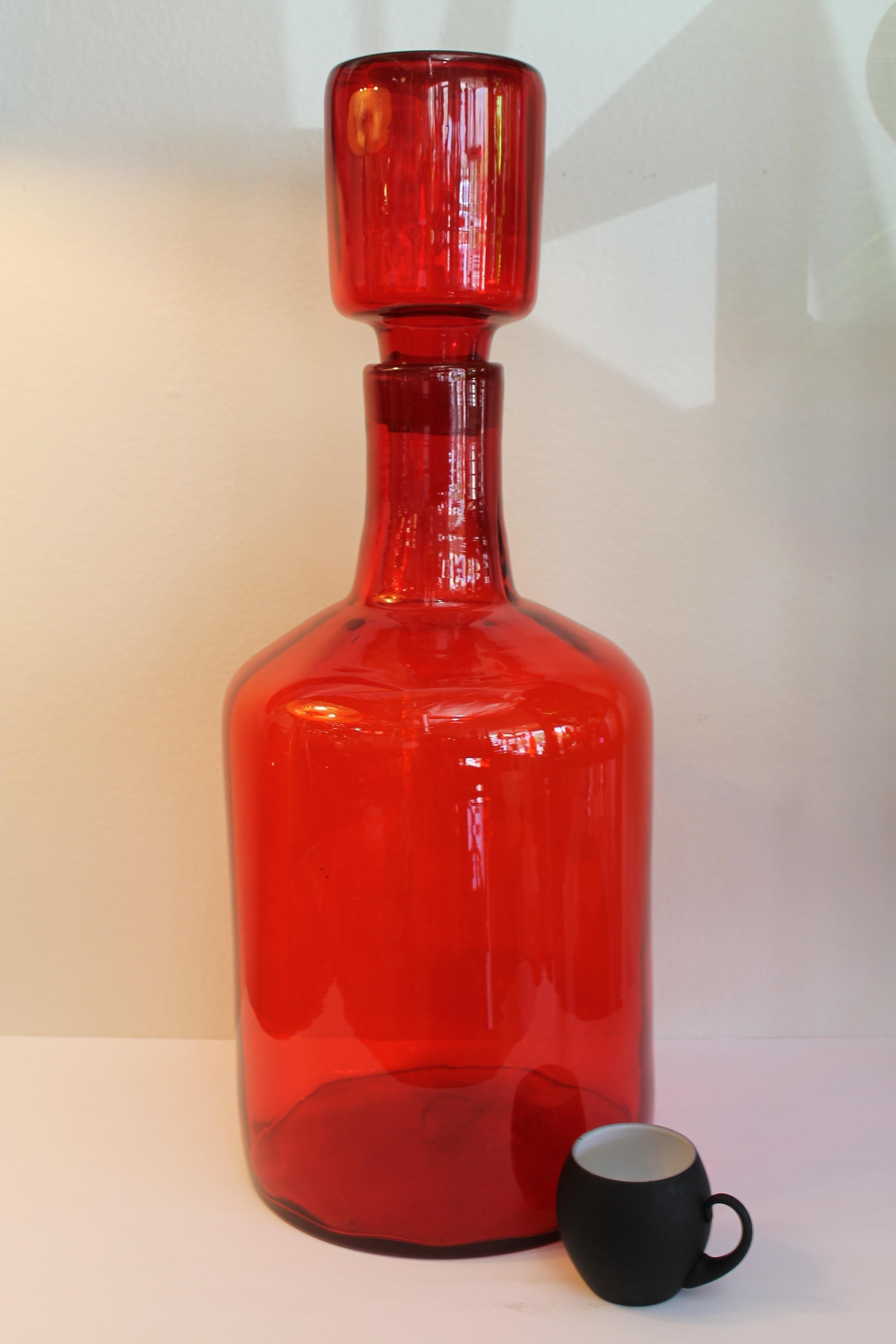 Architectural Blenko tangerine floor vessel/bottle with stopper by Wayne Husted. Bottle (without stopper) is 18
