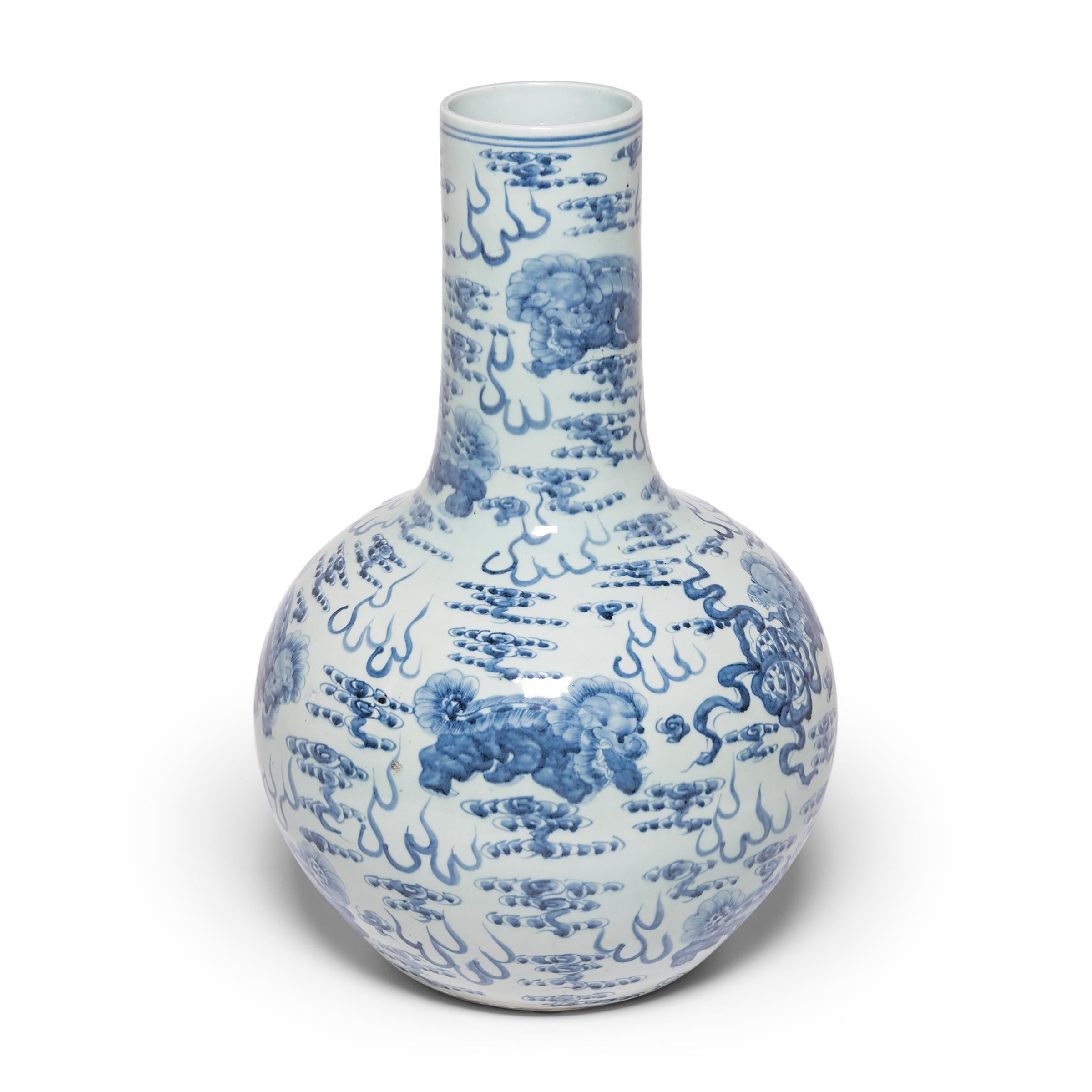Beautifully rendered with expressive brushwork, the painted decoration on this monumental globular jar demonstrates the exceptional artistry of Chinese blue-and-white porcelain. Guardian Fu lion dogs float amidst celestial clouds, playfully chasing