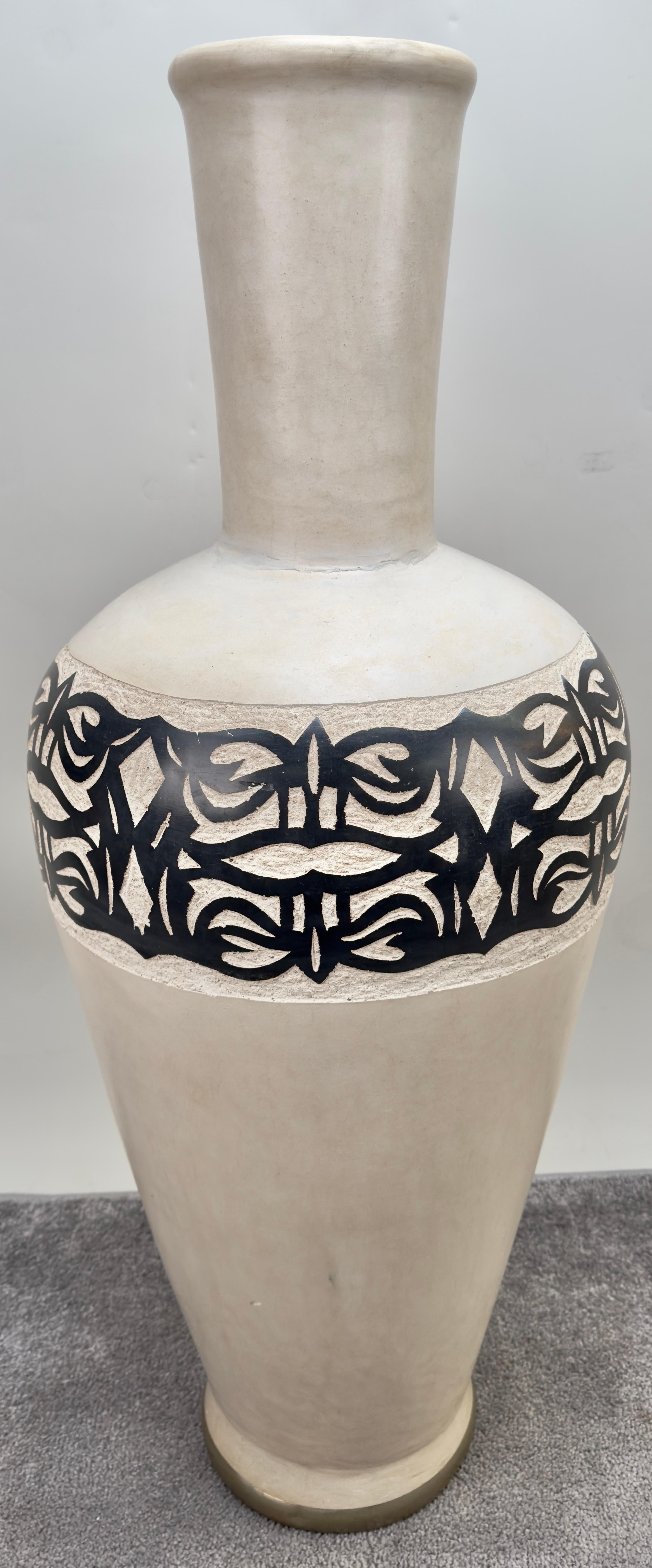 a magnificent monumental boho chic Moroccan handmade pottery floor vase made during late 20th century.  a testament to the artistry of skilled artisans. This exquisite artisan piece showcases a captivating earthy off-white natural hue and is adorned