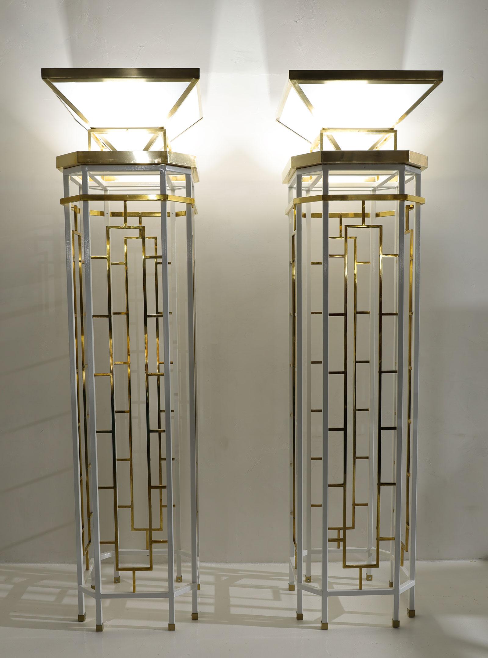 These massive and absolutely stunning Monumental Brass and Metal Torchieres are a true testament to mid-century modern elegance, expertly restored to their former glory. The metal, newly powder-coated in white, beautifully contrasts with the