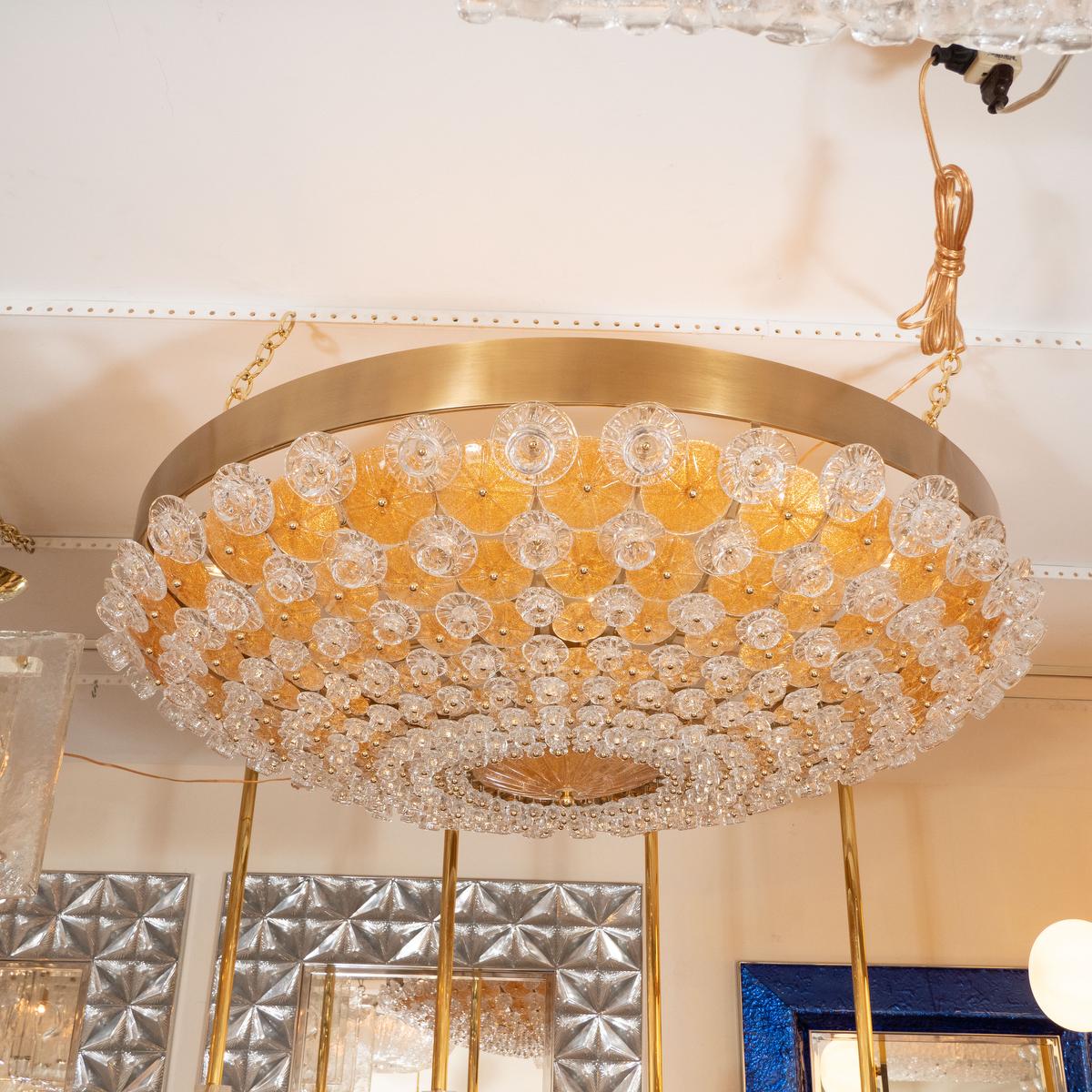 Monumental brass ceiling fixture composed of clear and amber glass flowers in the manner of Barovier.