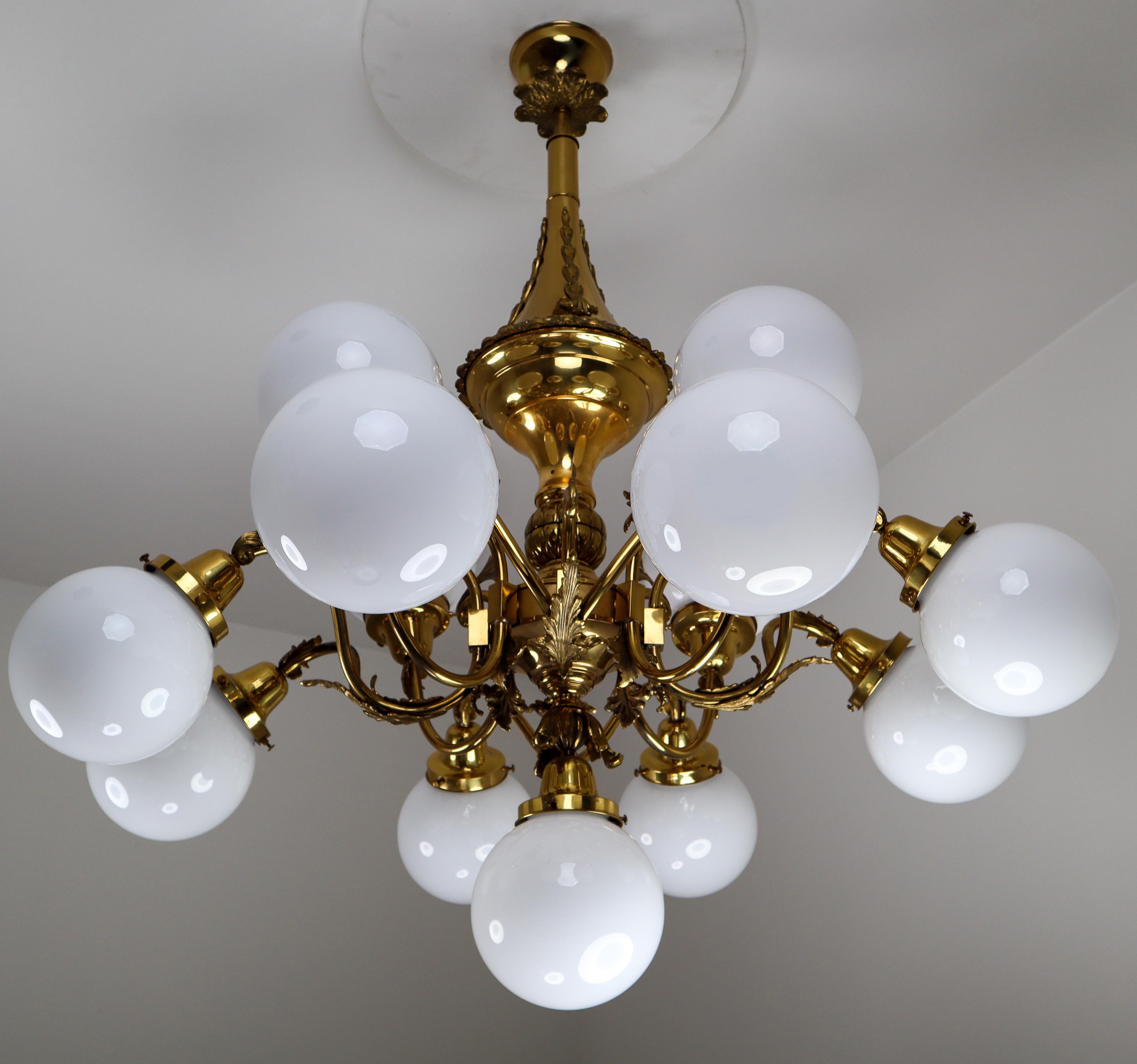 Monumental brass chandelier and four wall lights with opaline glass globes from the National Gallery Praque.

Monumental and chic design chandelier and four wall lights with high quality brass fixture and luxury opaline glass globes. This