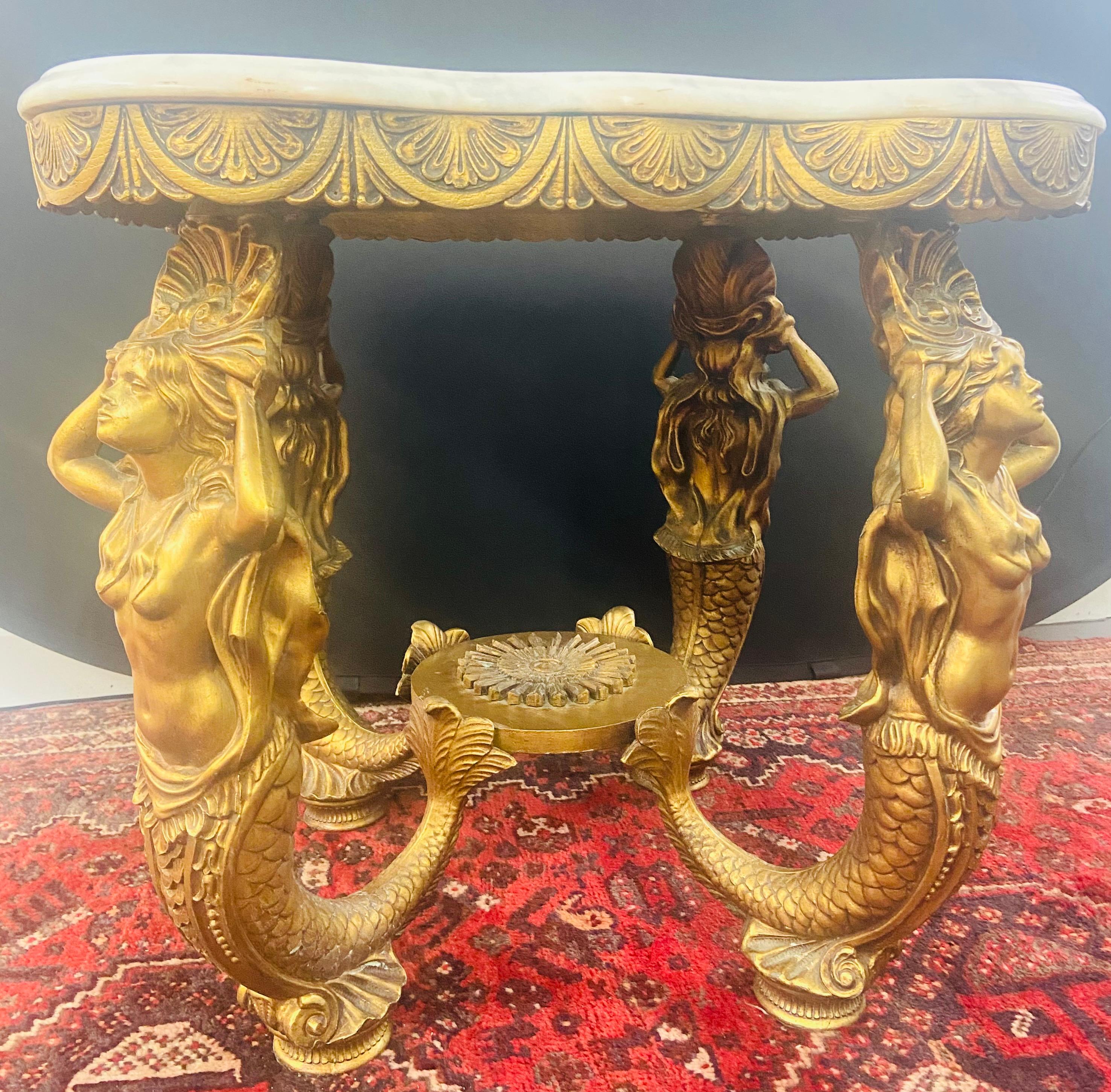 This stunning pair of end or side tables are undoubtedly exceptional art and collectible pieces. The table base features a four brass myth mermaid sculpture on each corner, a result of a labor intensive and time consuming hand sculpting and cast