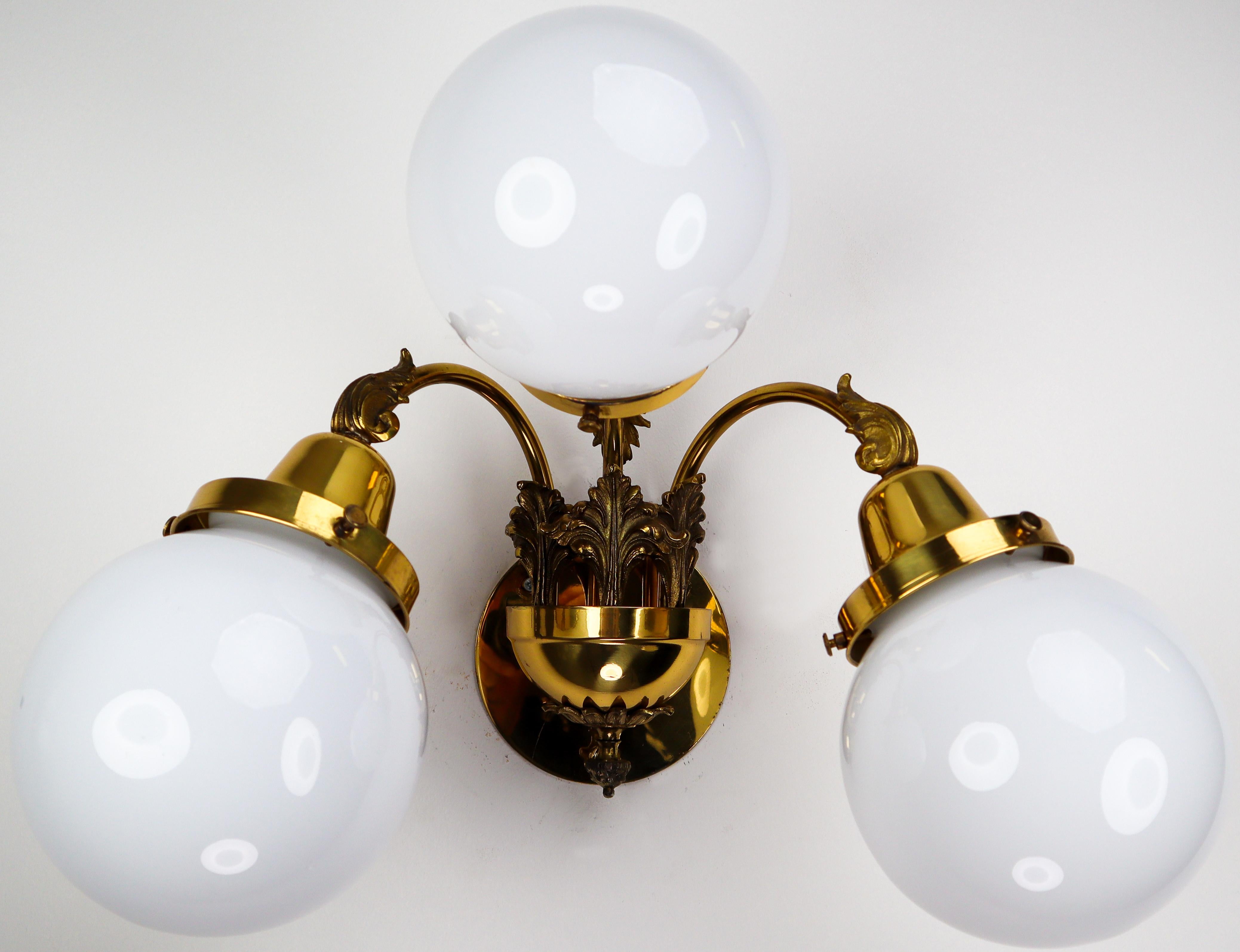 Monumental brass wall lights with opaline glass globes from the National Gallery Praque.

Monumental and chic design set of 16 chandeliers with high quality brass fixture and luxury opaline glass globes. These wall lights with brass frame consist