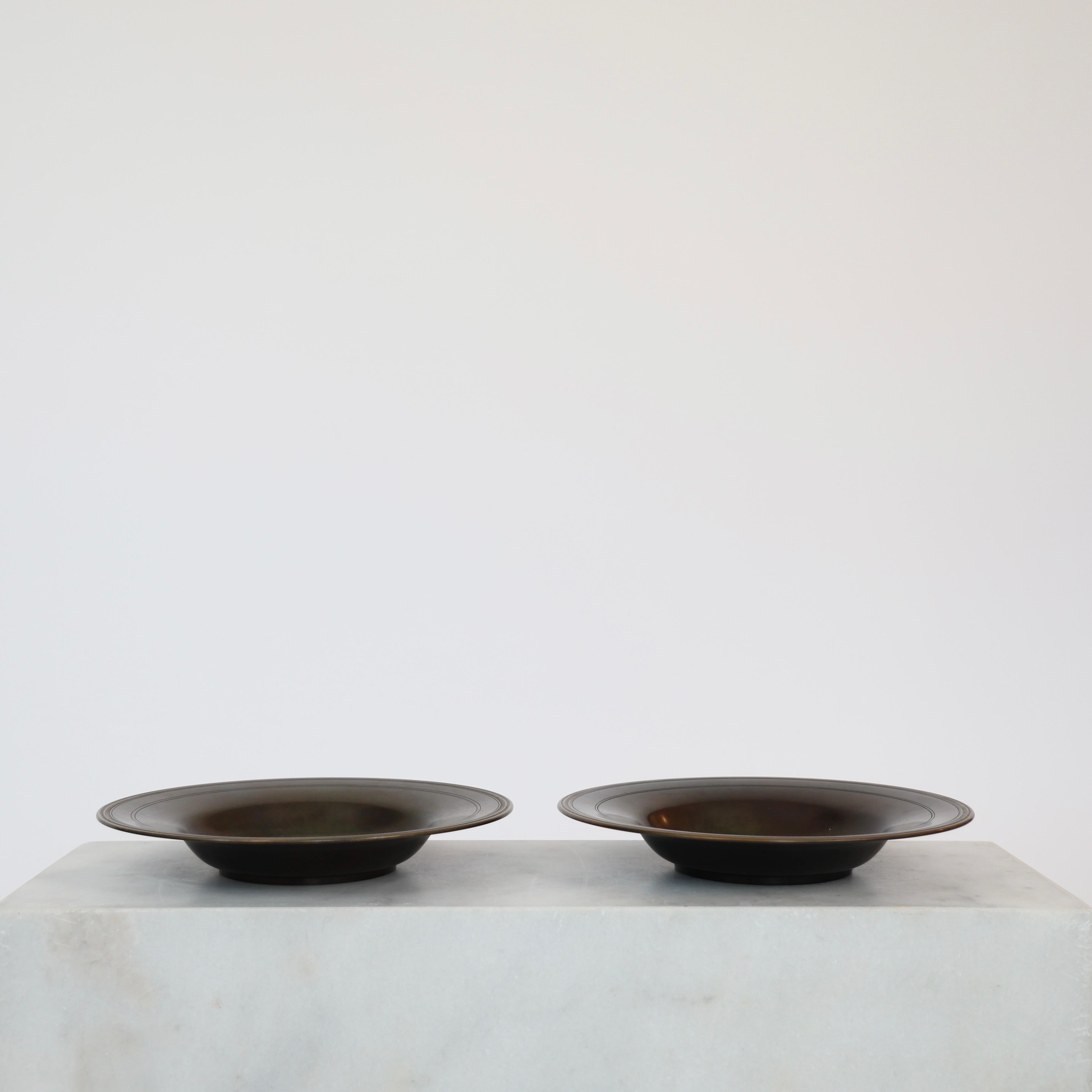 Set of Impressive Bronze Bowls in excellent vintage condition made by Just Andersen in the 1930s. 

* Set (2) of round bowl in full bronze with circular grooves and golden border bands.
* Designer: Just Andersen
* Model: B176
* Year: 1925-1930
*