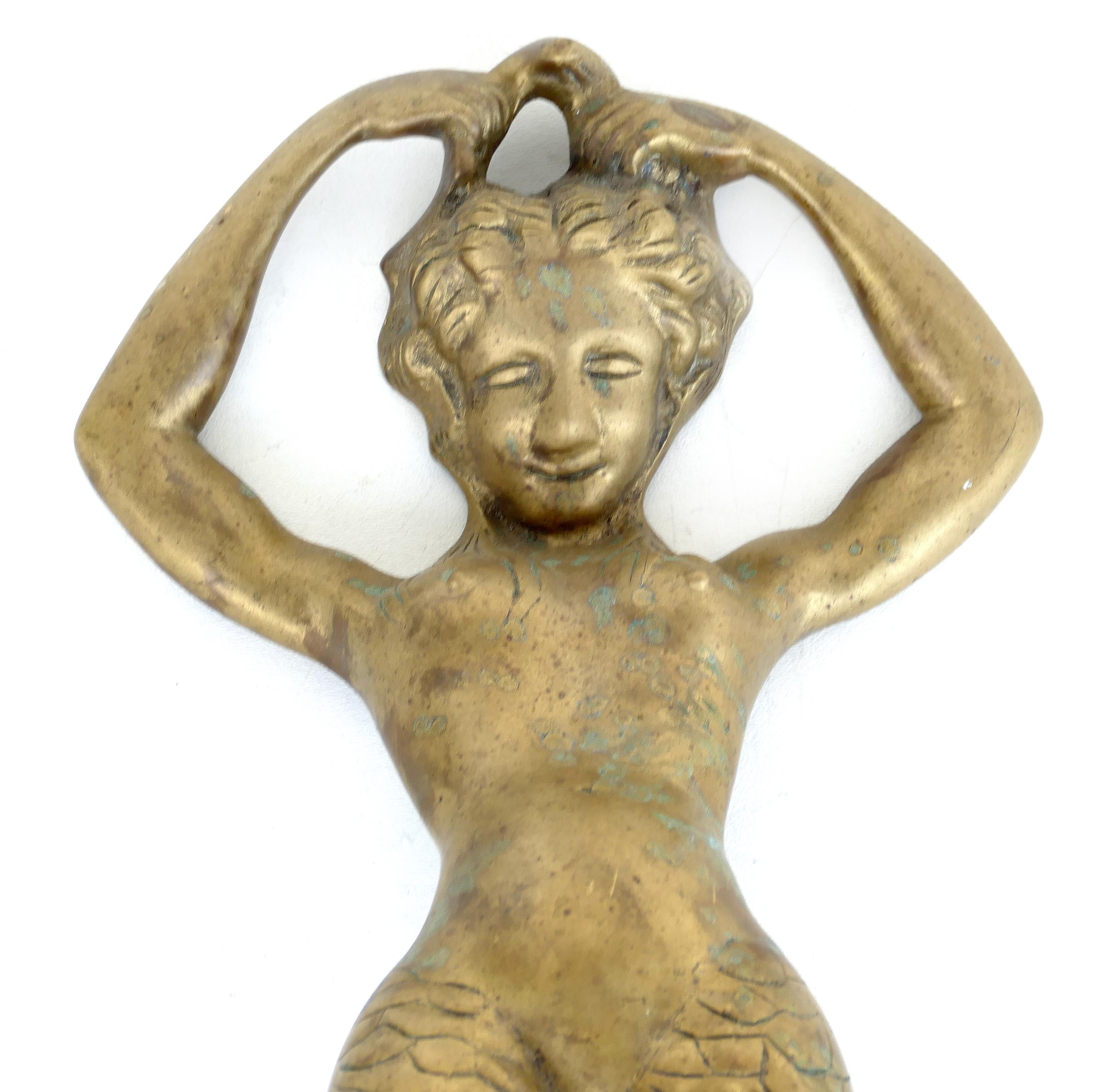 Monumental bronze mermaid handles or door knockers

Offered for sale is an overscale and substantial pair of bronze figural handles depicting mermaids. They could be retrofitted for use as door knockers  Each figure arches forward to create a