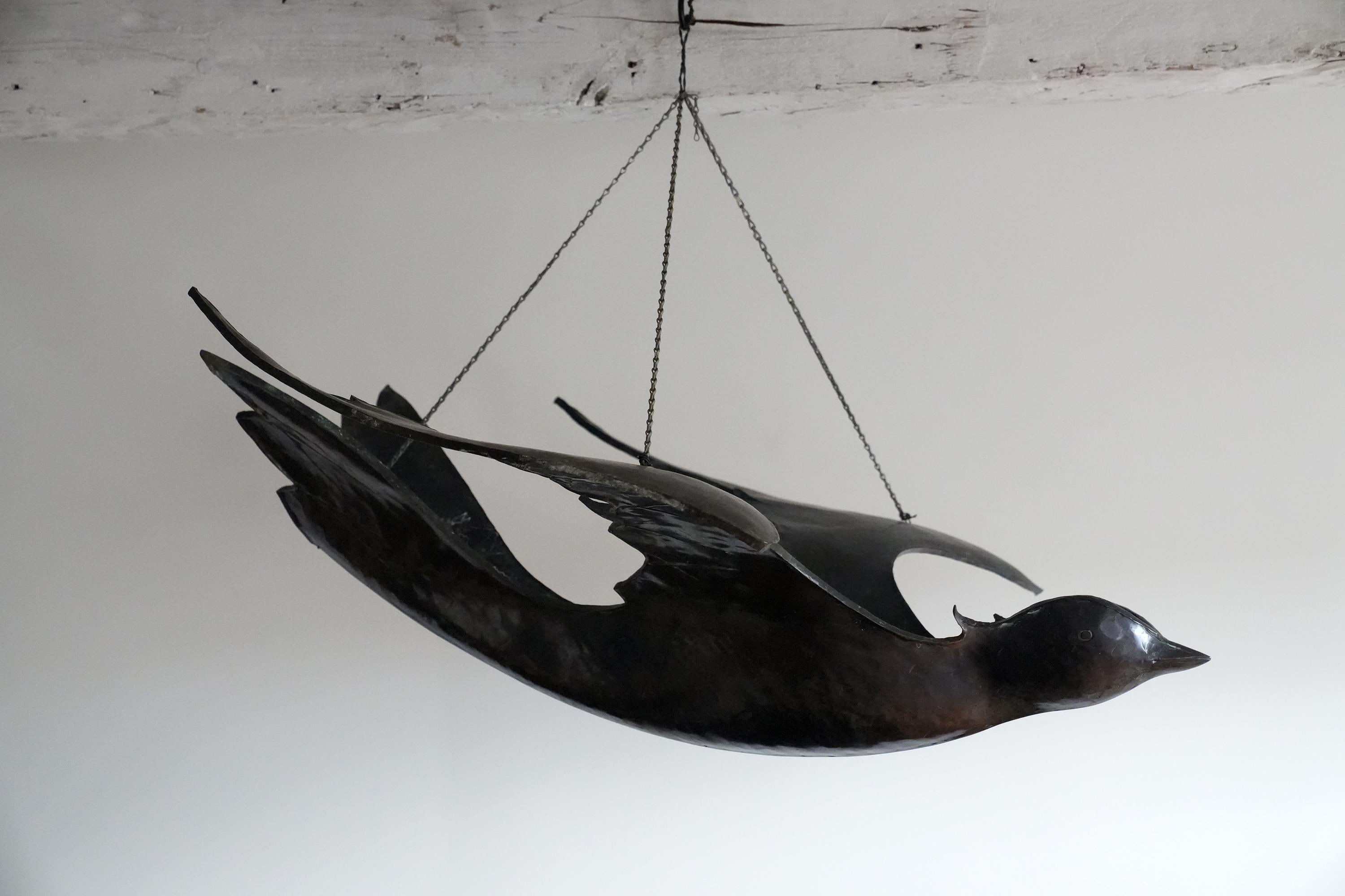 This is a one of a kind hand hammered and sculpted modernist bronze bird reminiscent of Lalanne. The body of the bird is lightly hammered with the suggestion of feathers incised on the wings and tail with a light patina throughout. Monumental in