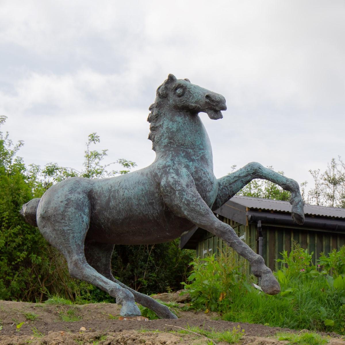 An Italian bronze sculpture titled 'Cavallo' by Luigi Broggini 1966 signed to the underbelly and stamped Fondrie Cu-bro, Novate (mi). This monumental sculpture was made using the lost wax process and has developed a beautiful verdigris