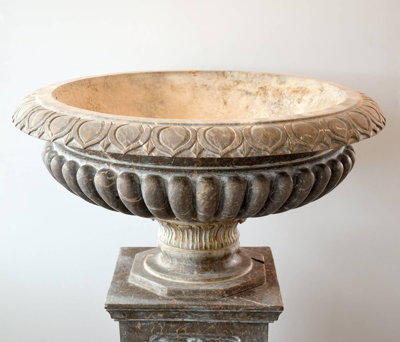Hand-carved in Italy, this monumental brown marble planter measures 50