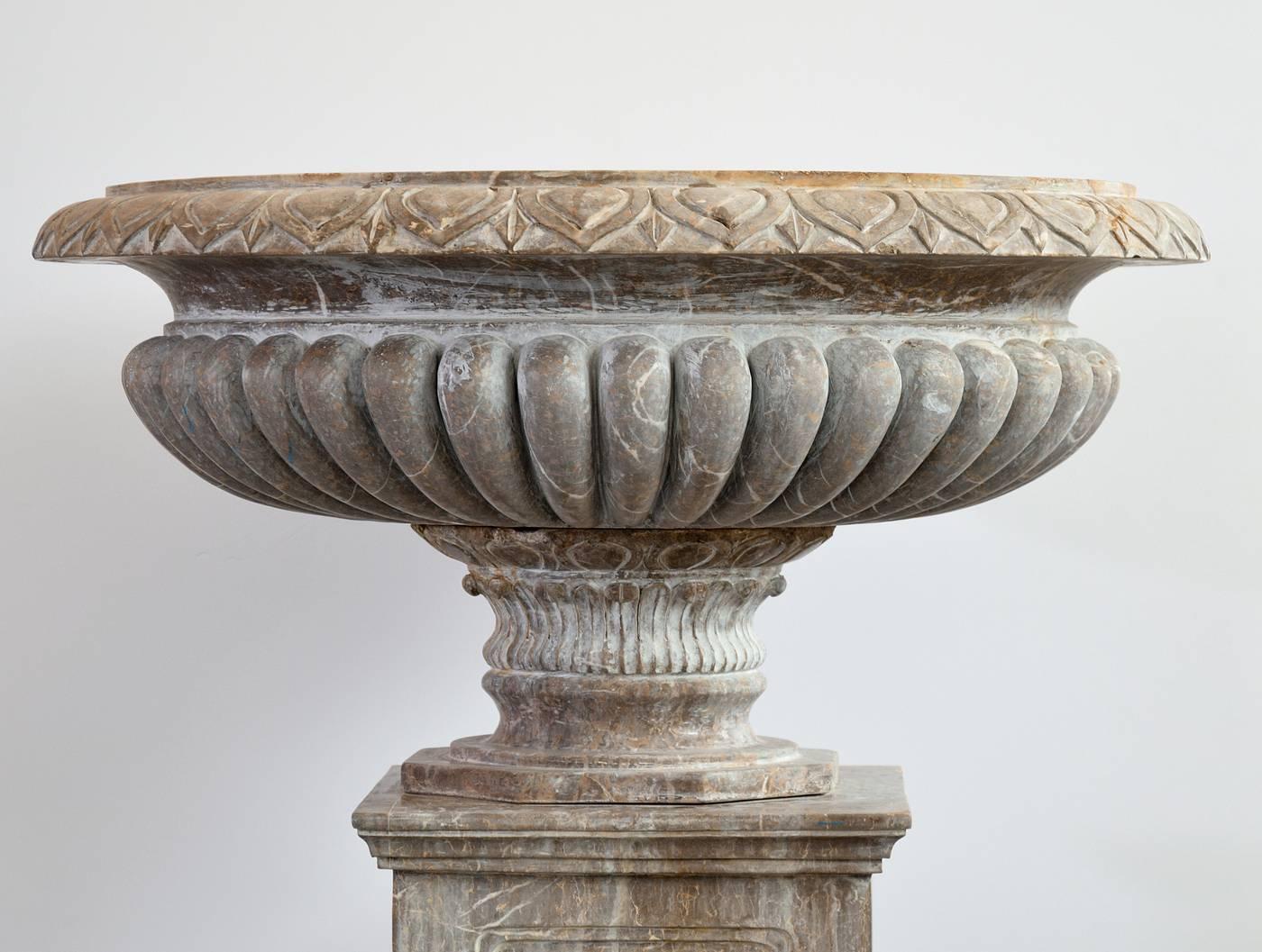 Hand-carved in Italy, this monumental brown marble planter measures 50