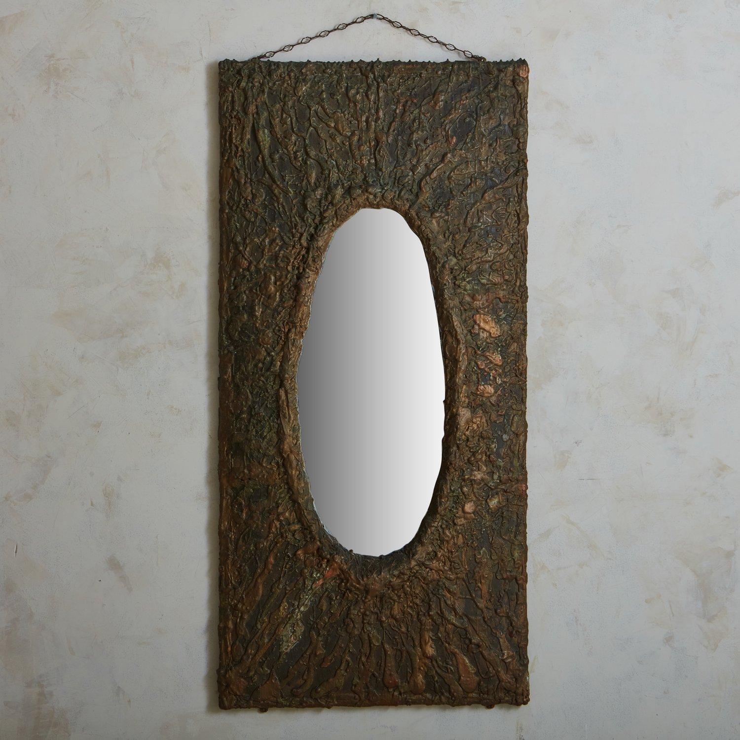 A monumental 1980s Italian mirror featuring a textured rectangular frame constructed with copper and resin with a beautiful green hue. The frame supports an inset oval mirror. Unmarked. Sourced in Italy, 1980s.