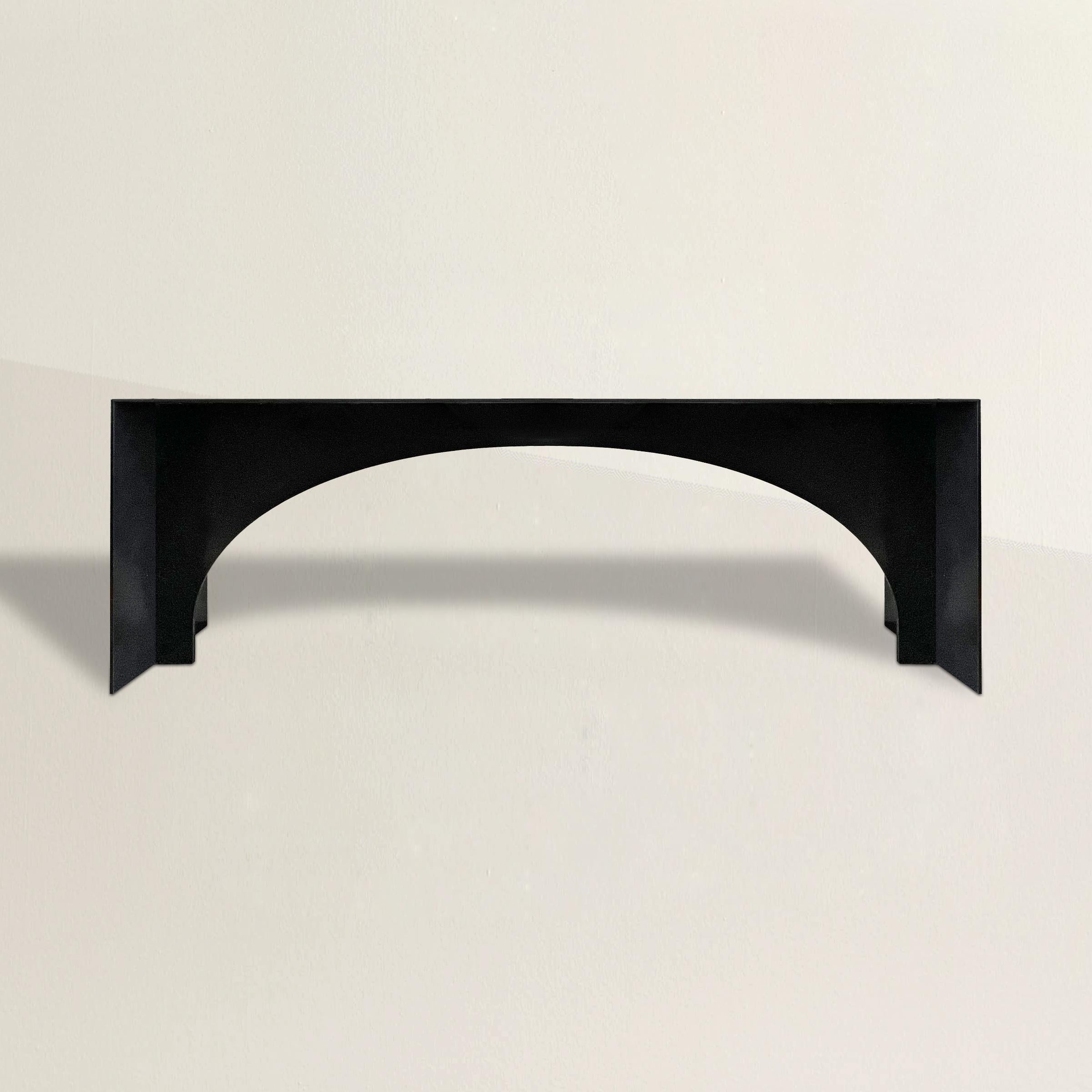 A stunning and memorable contemporary Brutalist-inspired monumental steel console table constructed from 3/8 inch thick steel and with an arched apron between two waterfall legs. The perfect console table in your entry, sideboard in your dining