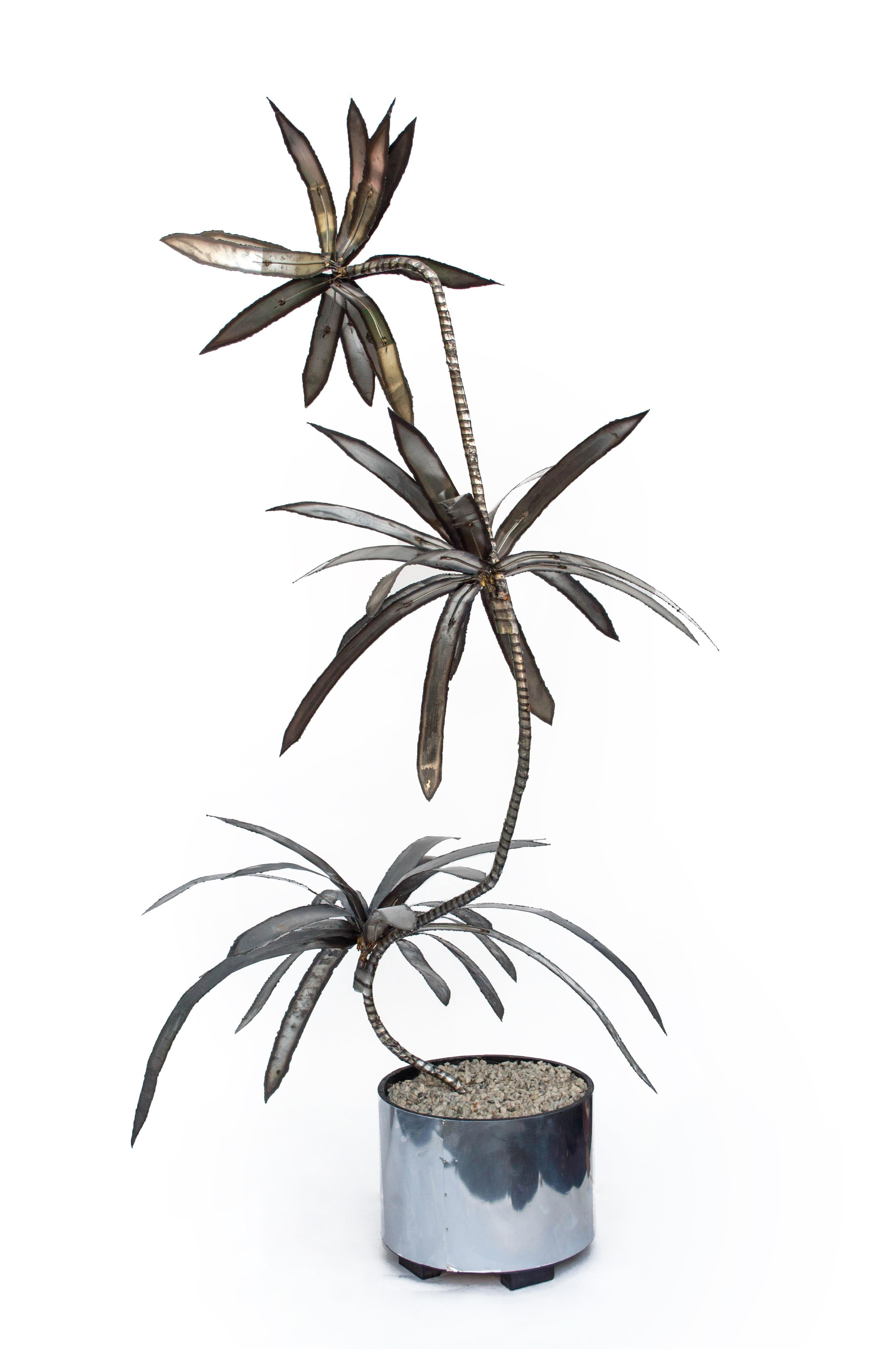 Talk about a total looker, this one-of-a-kind vintage torch welded Brutalist tree is a beaut! Impressive at over 6 feet tall, each leaf was torch cut and welded to create this dynamic metal palm tree. The leaves are pliable allowing you to arrange