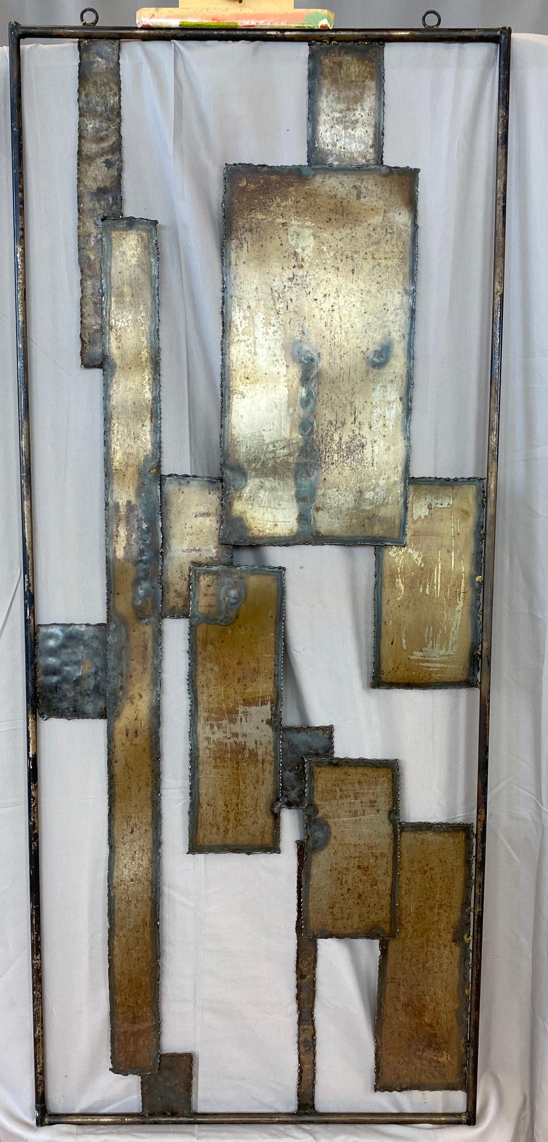 Offered here is a monumental in size brutalist in style wall mount sculpture circa 1970s. Unsigned.
The sculpture has the same feel of the techniques you'll find on the works of Silas Seandel. 
Made of steel and brass with shapes of squares,