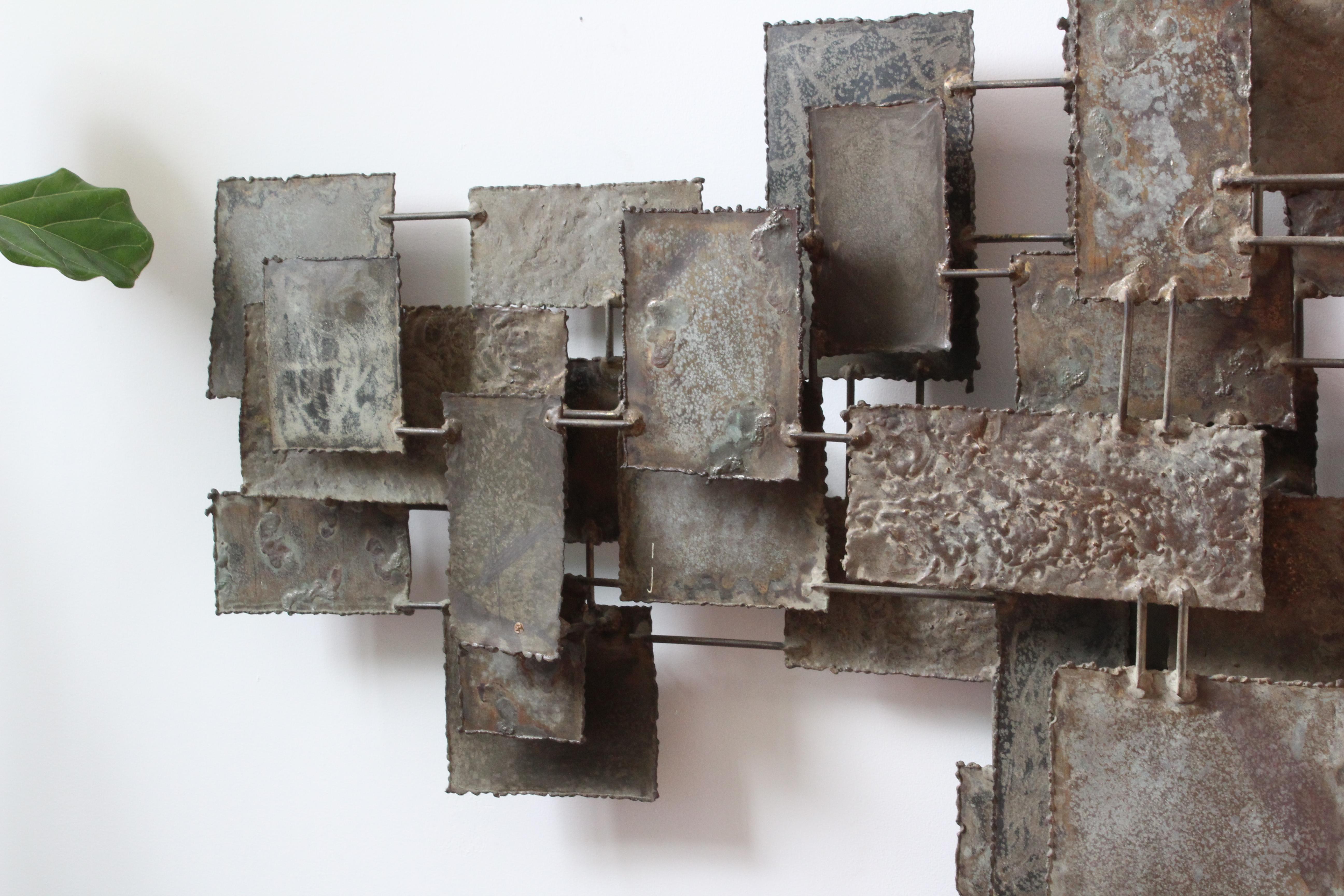 Monumental torch cut steel wall sculpture by Silas Seandel from the 1960s. This piece measures 7 feet wide and 47 inches deep and protrudes 6 inches off the wall. Overall this piece is in wonderful condition.