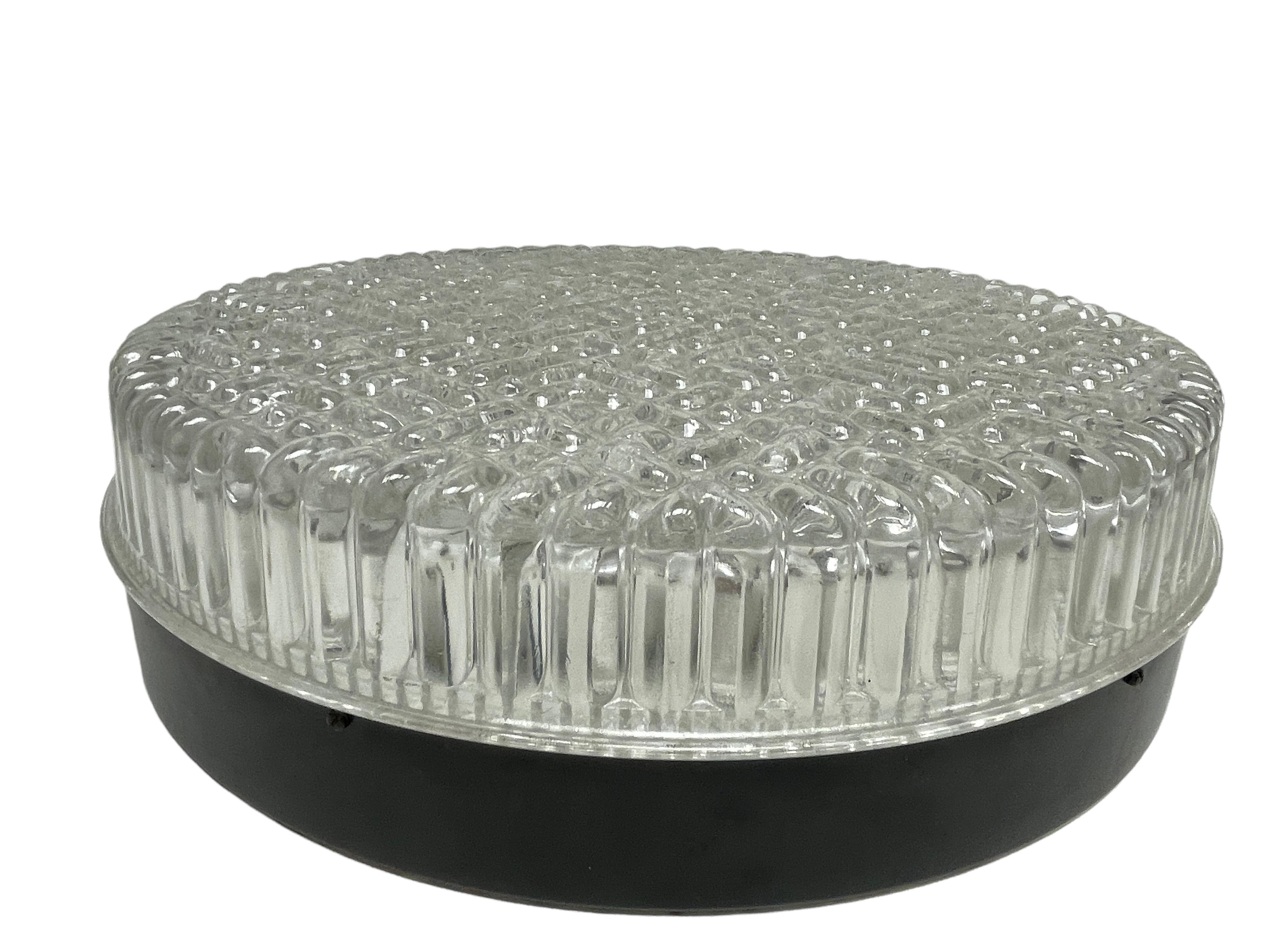 A beautiful flush mount ceiling light. Made in Germany by Glashütte Limburg. Gorgeous textured glass flush mount with metal fixture. The glass has a very heavy glass with a bubble design. The fixture requires three European E27 / 110 Volt Edison