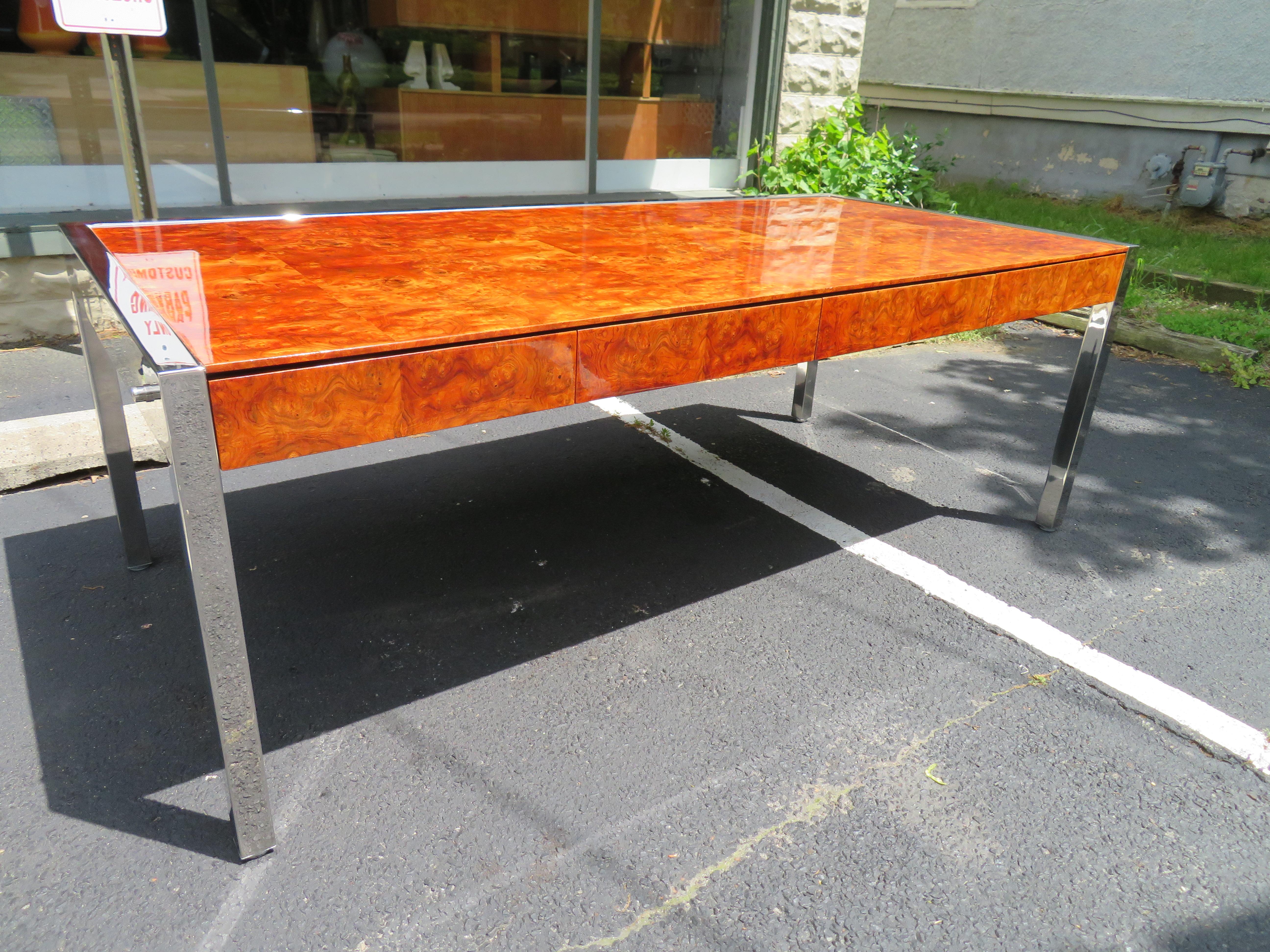 Monumental burl walnut and stainless steel modernist desk by Leon Rosen for Pace. This is one of those pieces that takes your breath away when you see it-totally off the hook! The desk has 4 drawers on the working side and 2 pull-out signing